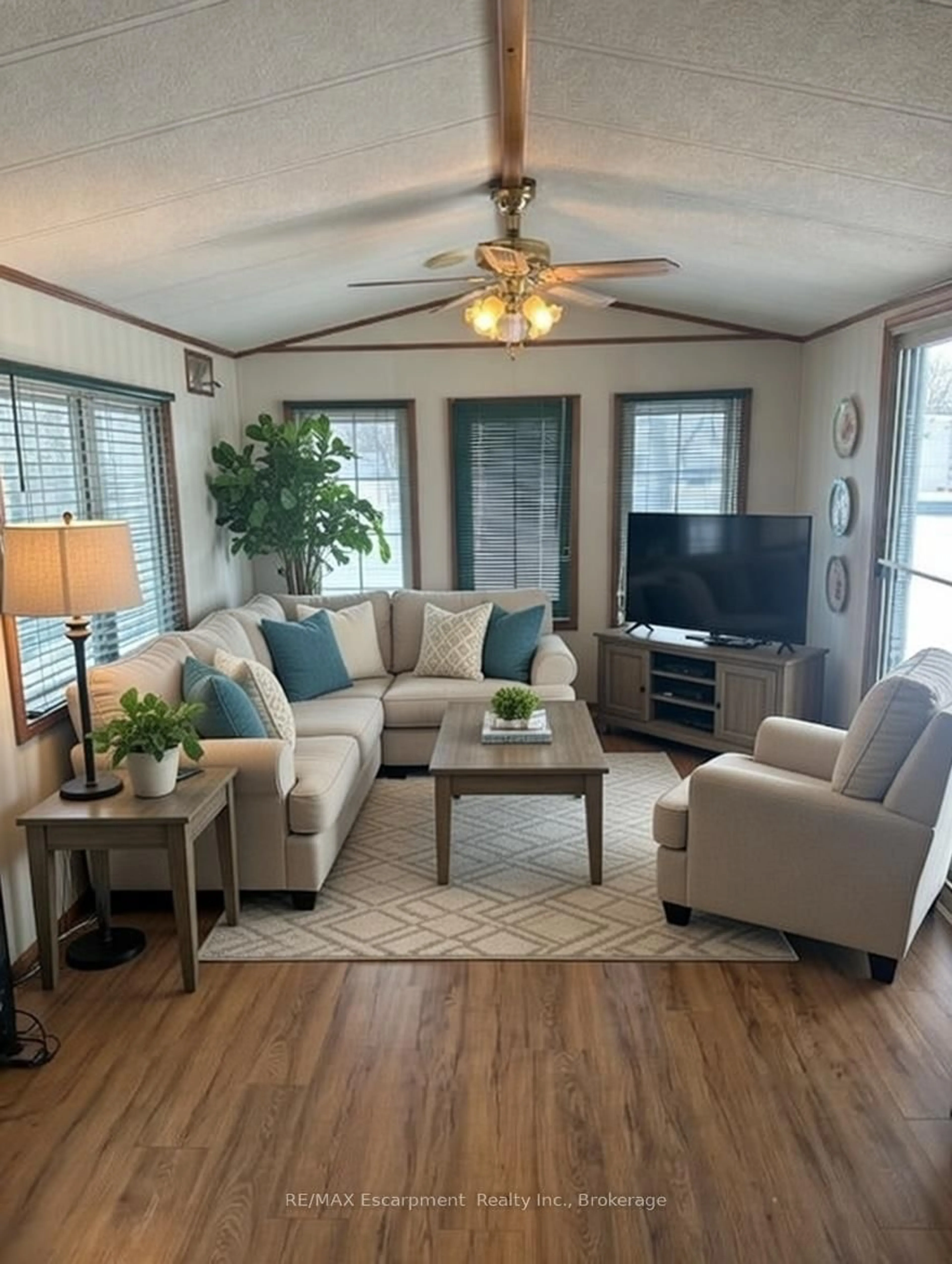 Living room with furniture, wood/laminate floor for 8845 Lundy's Lane #232, Niagara Falls Ontario L2H 1H5