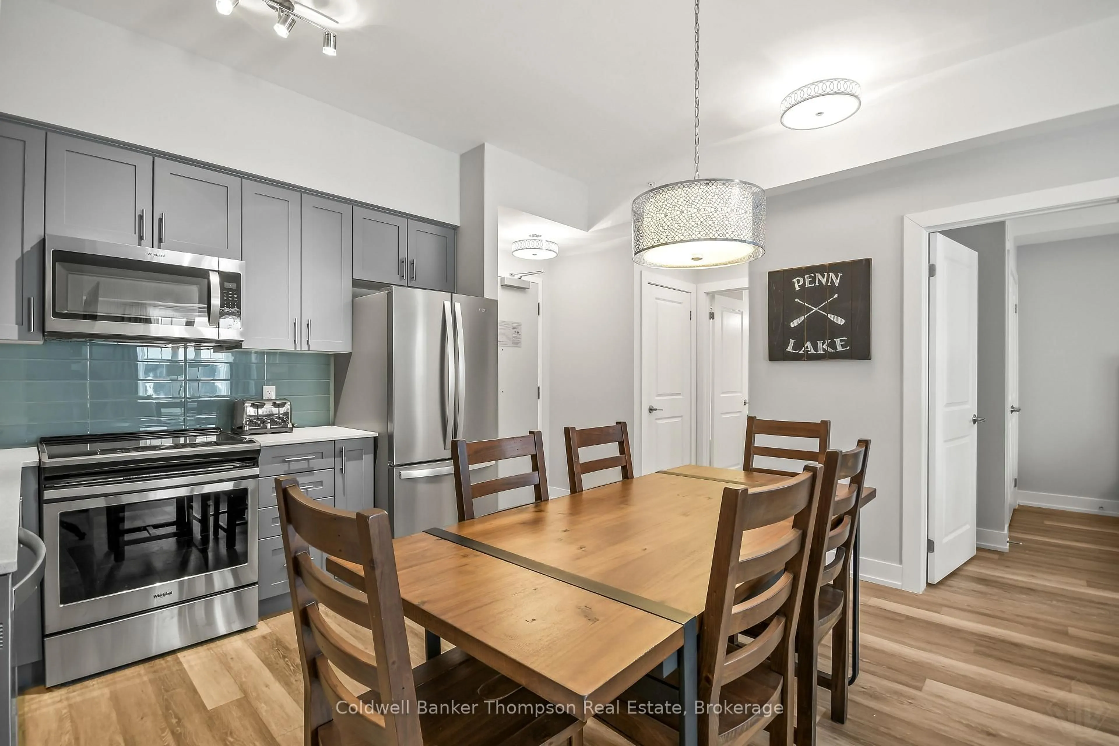 Open concept kitchen, wood/laminate floor for 25 PEN LAKE POINT Rd #403, Huntsville Ontario P1H 1A9