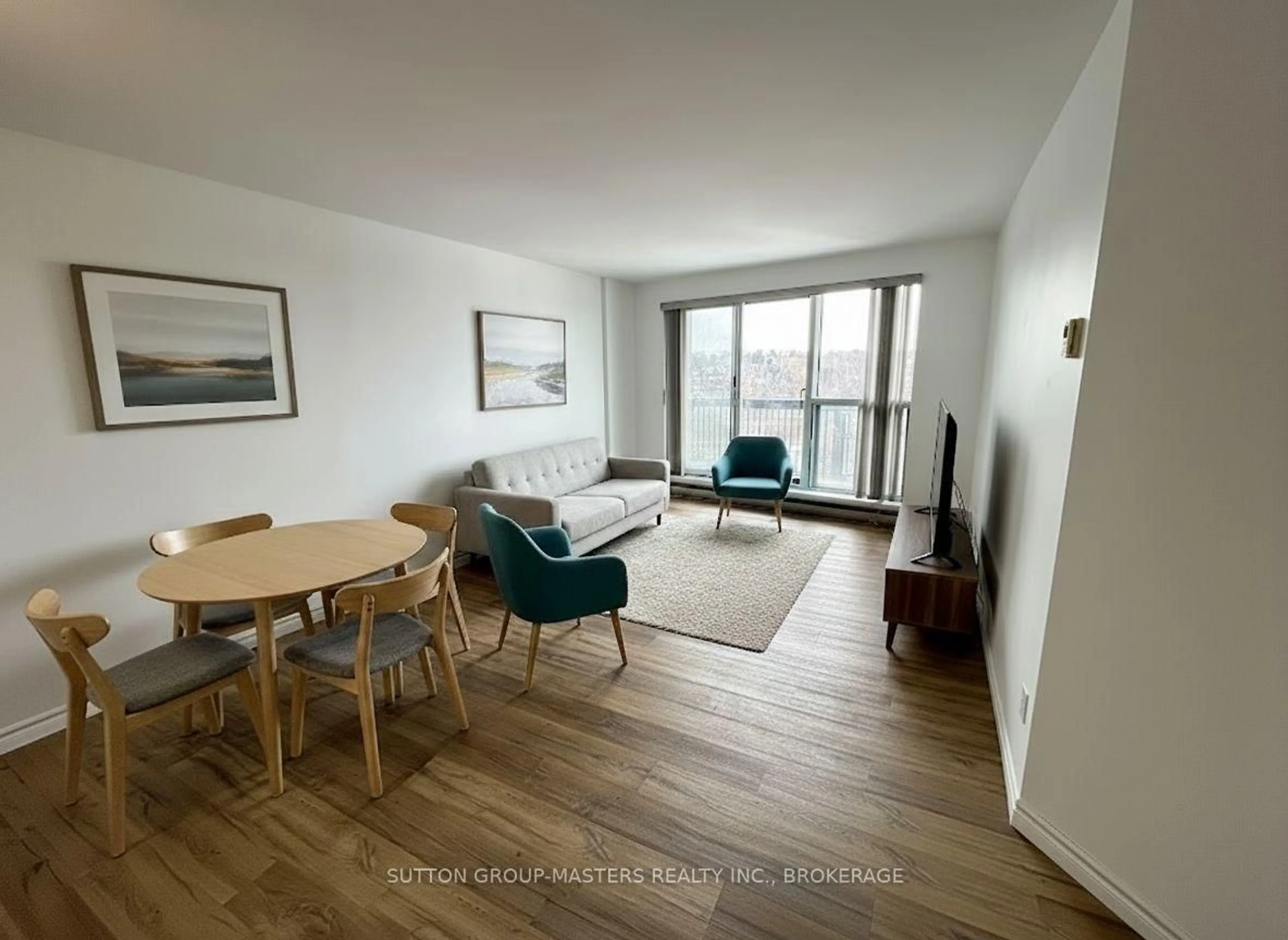 Living room with furniture, wood/laminate floor for 66 Greenview Dr #902, Kingston Ontario K7M 7C5