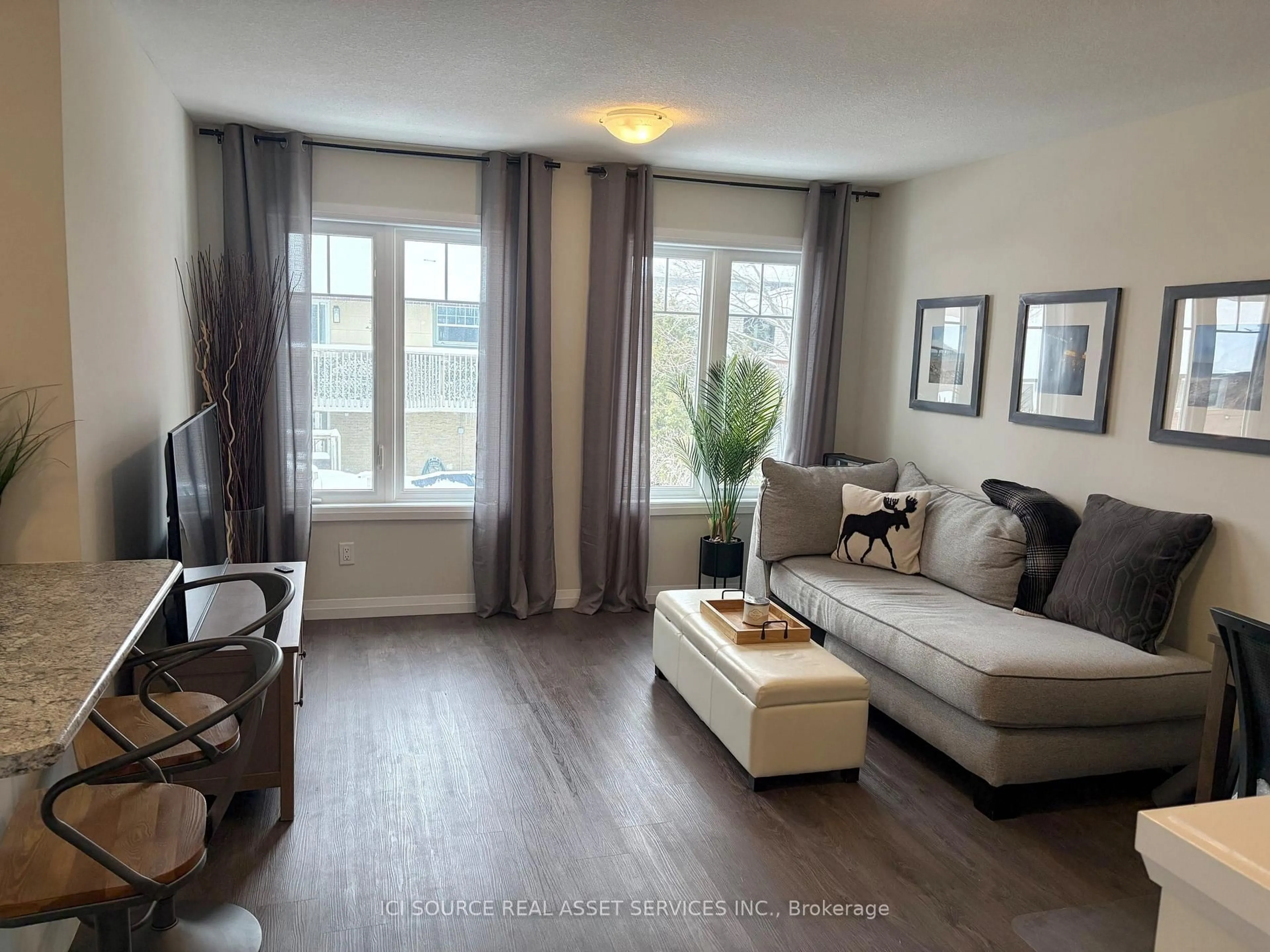 Living room with furniture, wood/laminate floor for 24 Morrison Rd #A13, Kitchener Ontario N2A 0L1