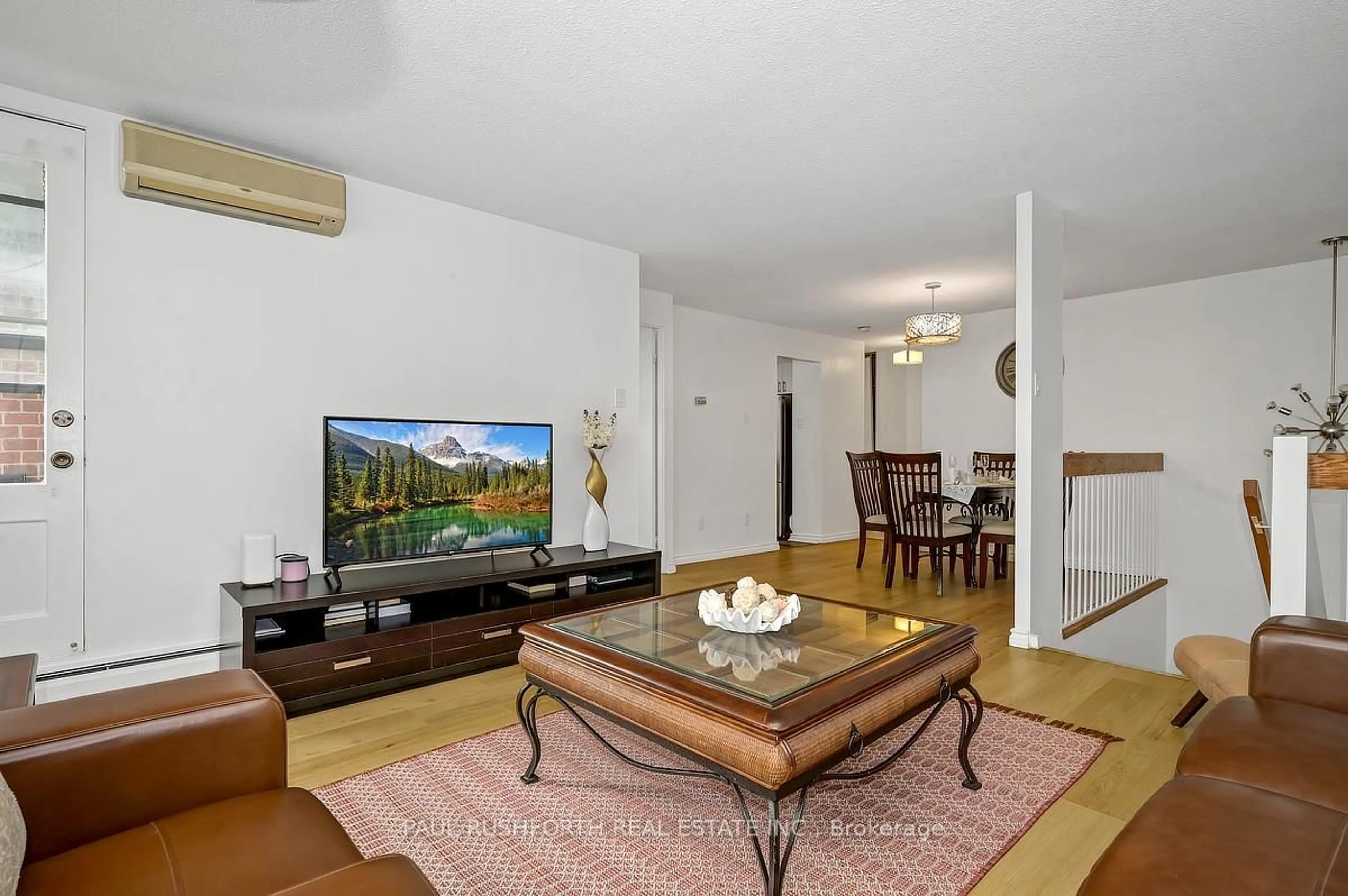 Living room with furniture, wood/laminate floor for 2650 Southvale Cres #417, Ottawa Ontario K1B 4S9