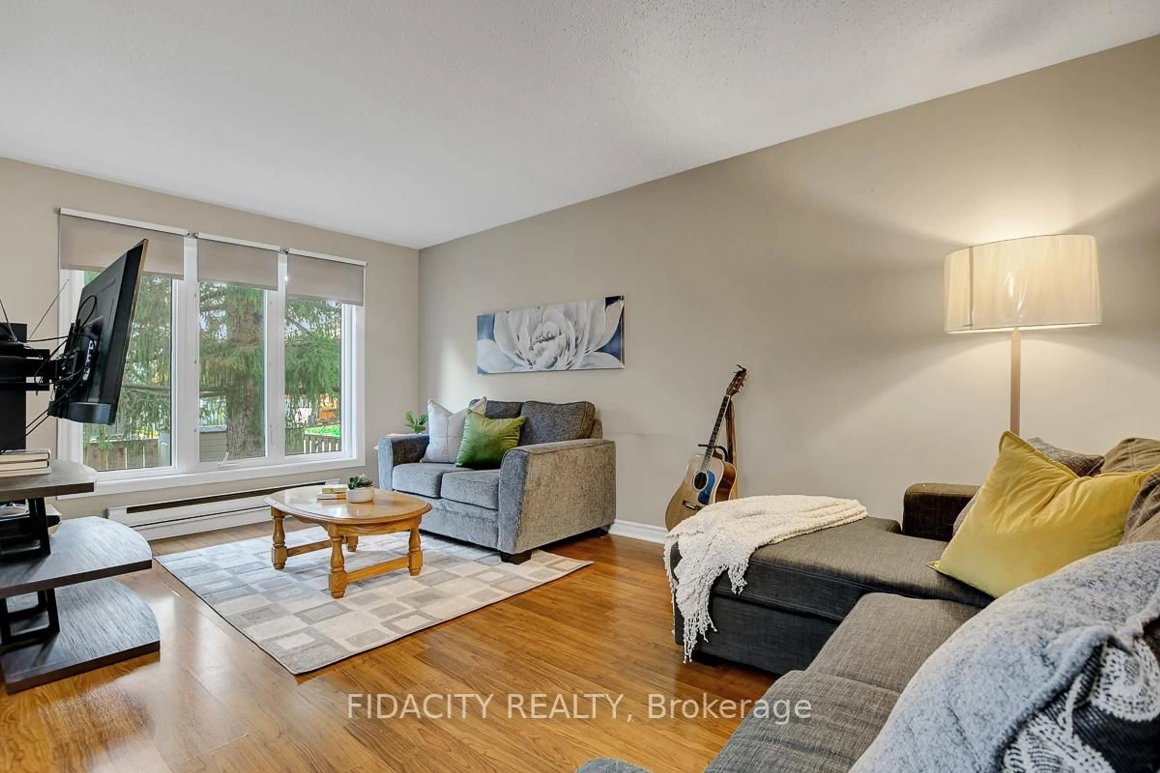 Living room with furniture, wood/laminate floor for 159 Salter Cres #61, Kanata Ontario K2K 1Y8