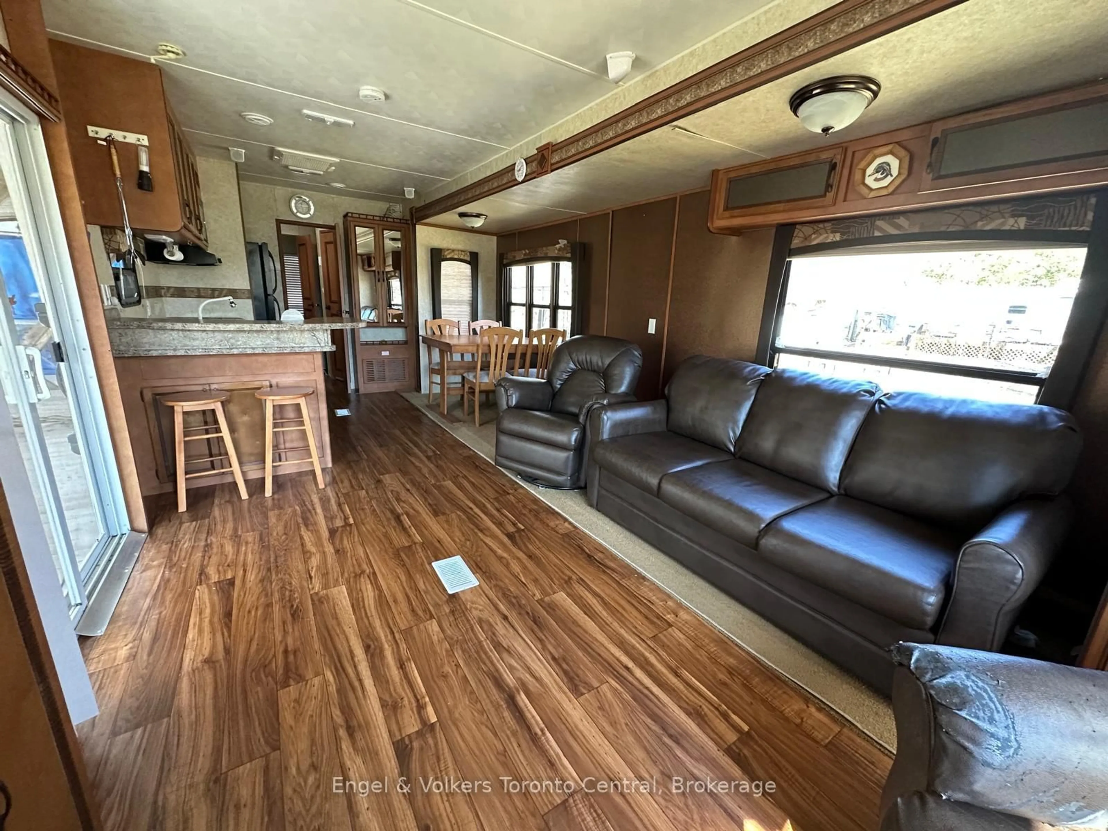 Living room with furniture, wood/laminate floor for 7489 SIDERAOD 5 E #S 14, Wellington North Ontario N0G 2L0