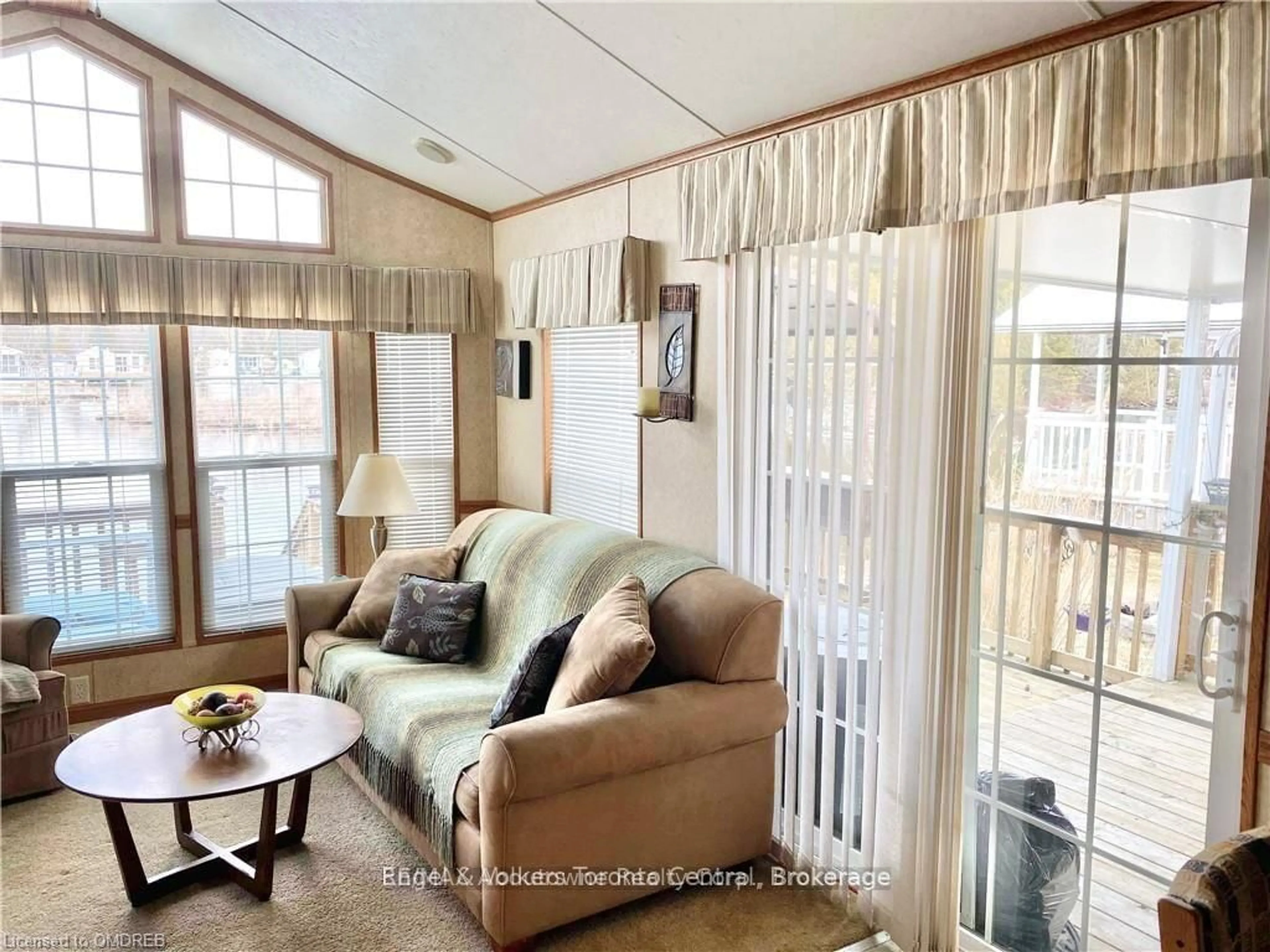 Living room with furniture, wood/laminate floor for 7489 SIDEROAD 5 #T106, Wellington North Ontario N0G 2L0