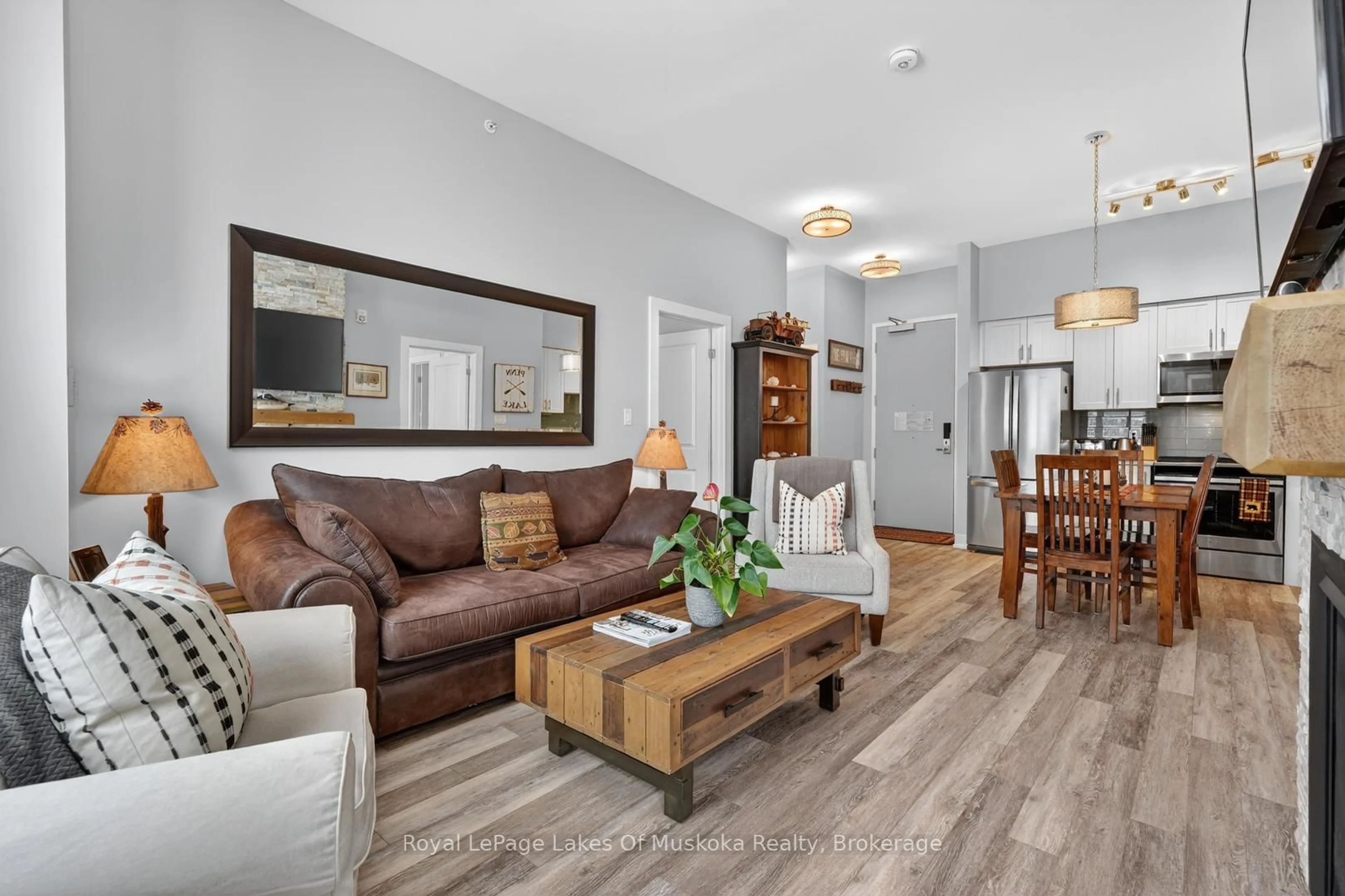 Living room with furniture, wood/laminate floor for 25 Pen Lake Point Rd #102, Huntsville Ontario P1H 1A9