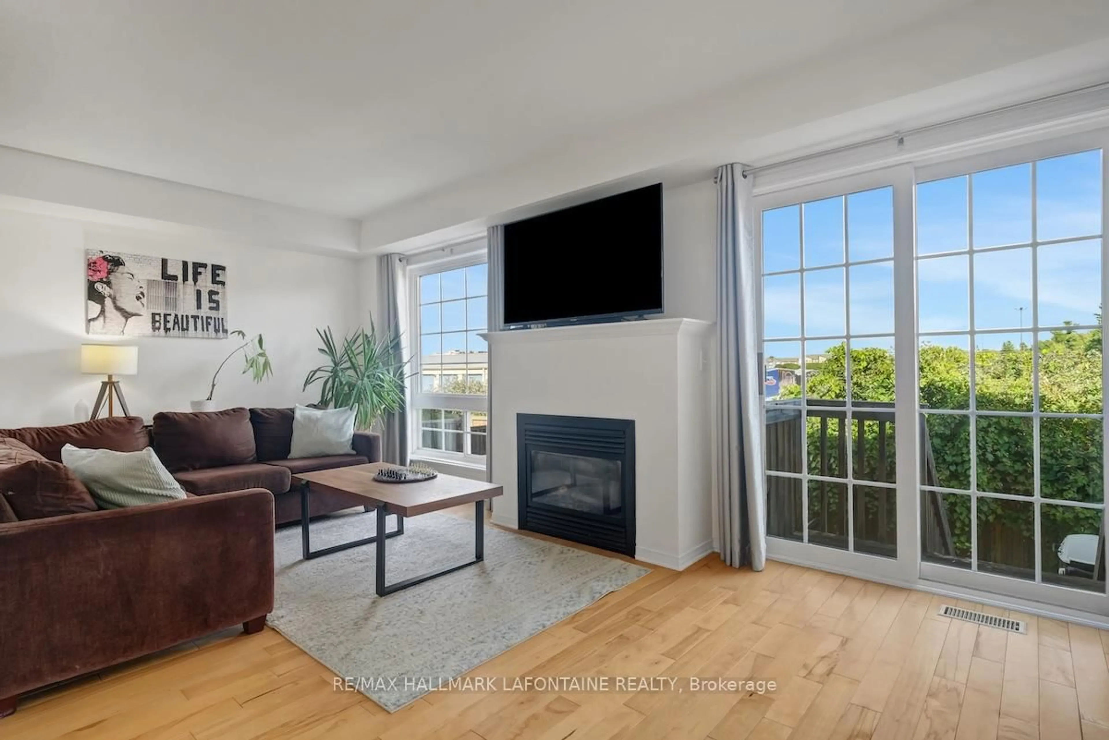 Living room with furniture, wood/laminate floor for 442 Wisteria Cres, Ottawa Ontario K1V 0P1