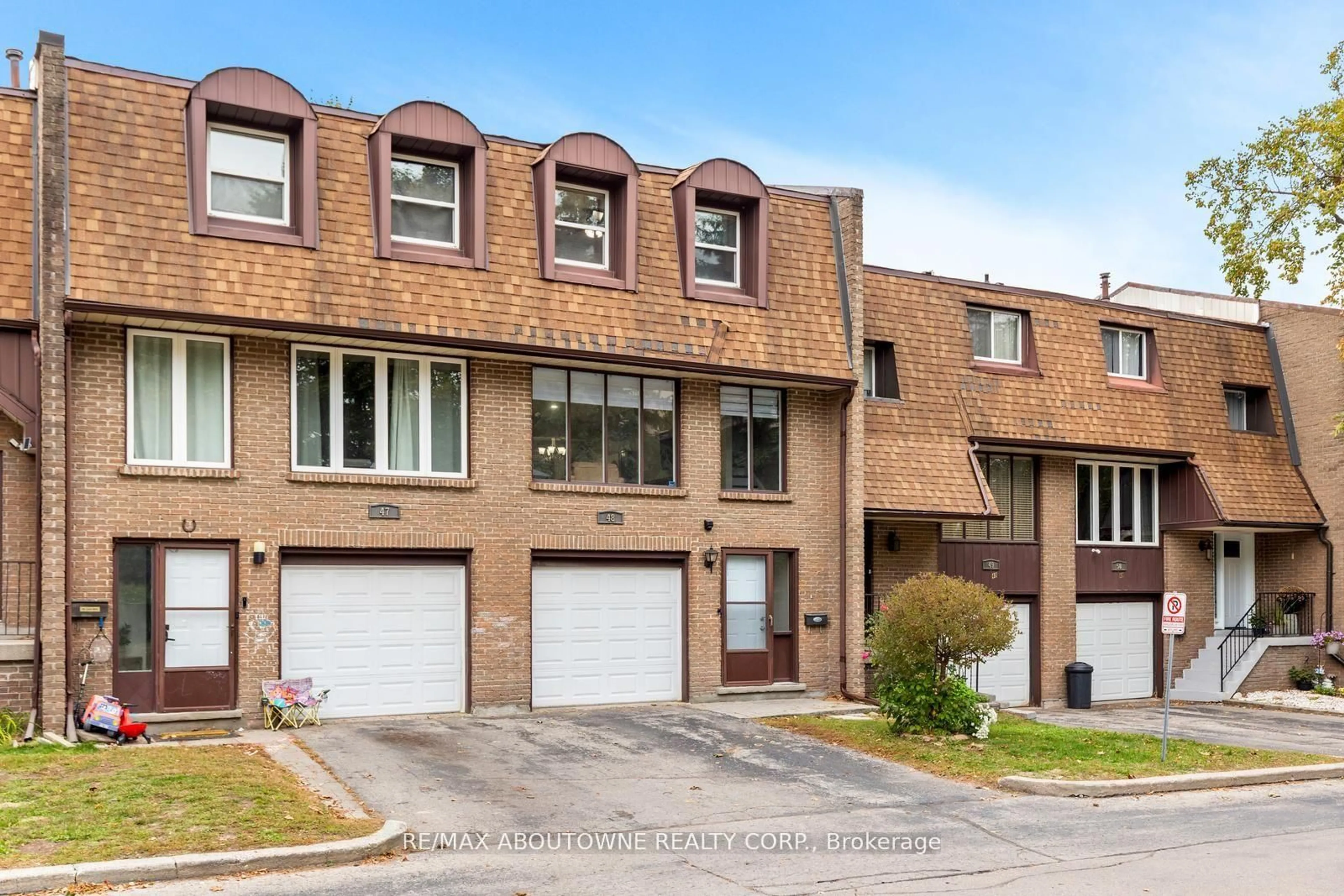 Home with brick exterior material, street for 49 Cedarwoods Cres #48, Kitchener Ontario N2C 2L1