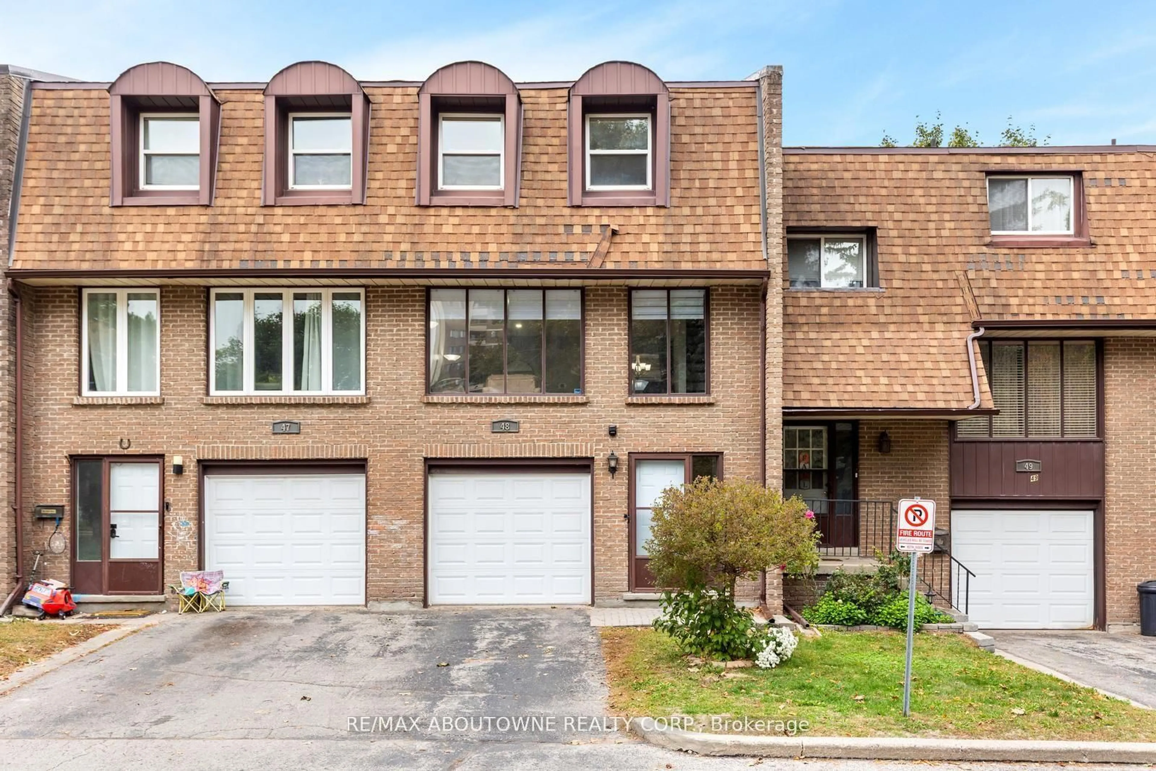 Home with brick exterior material, street for 49 Cedarwoods Cres #48, Kitchener Ontario N2C 2L1