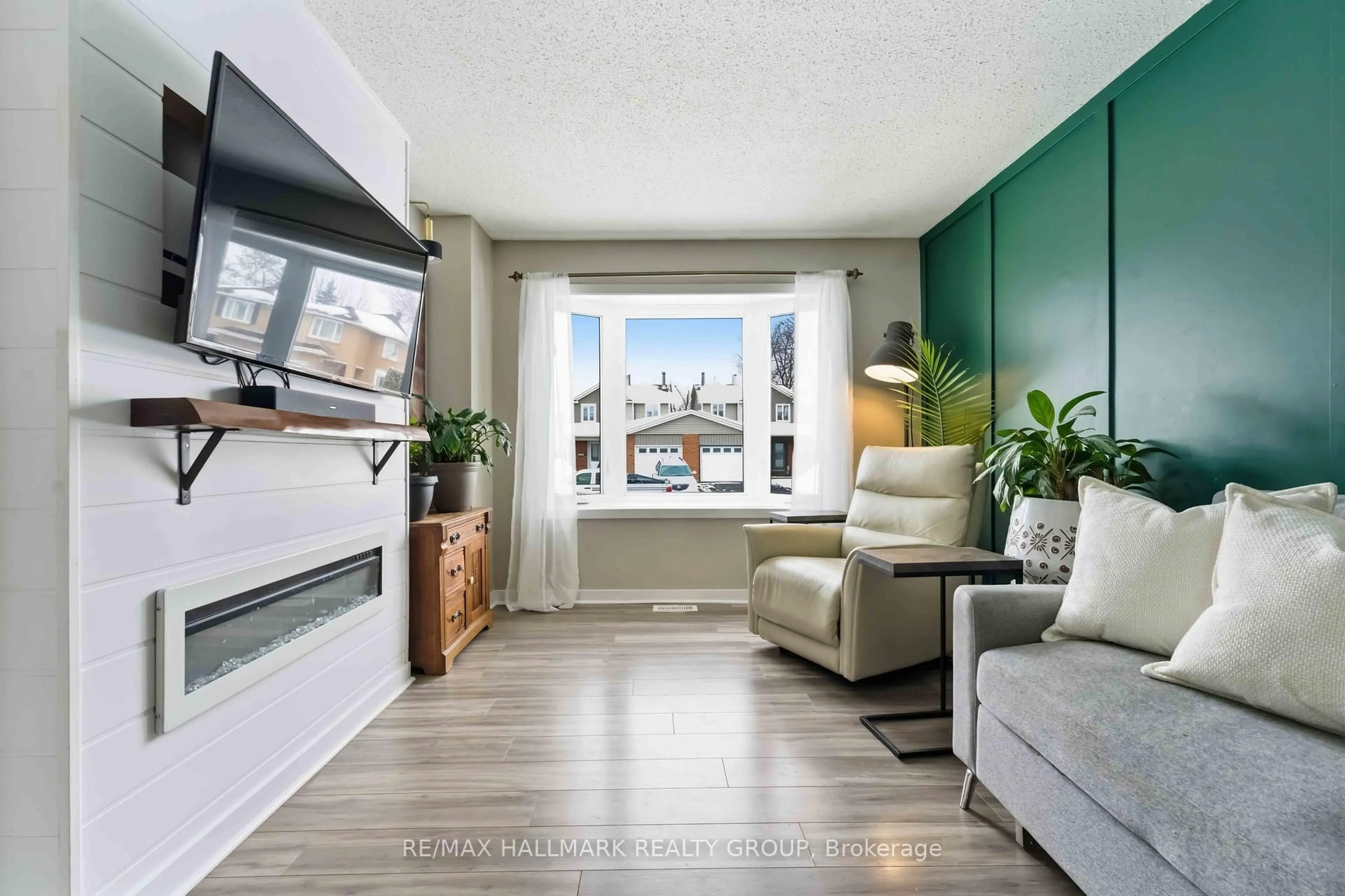 Living room with furniture, wood/laminate floor for 1091 Burgundy Lane, Orleans Ontario K1C 2M9