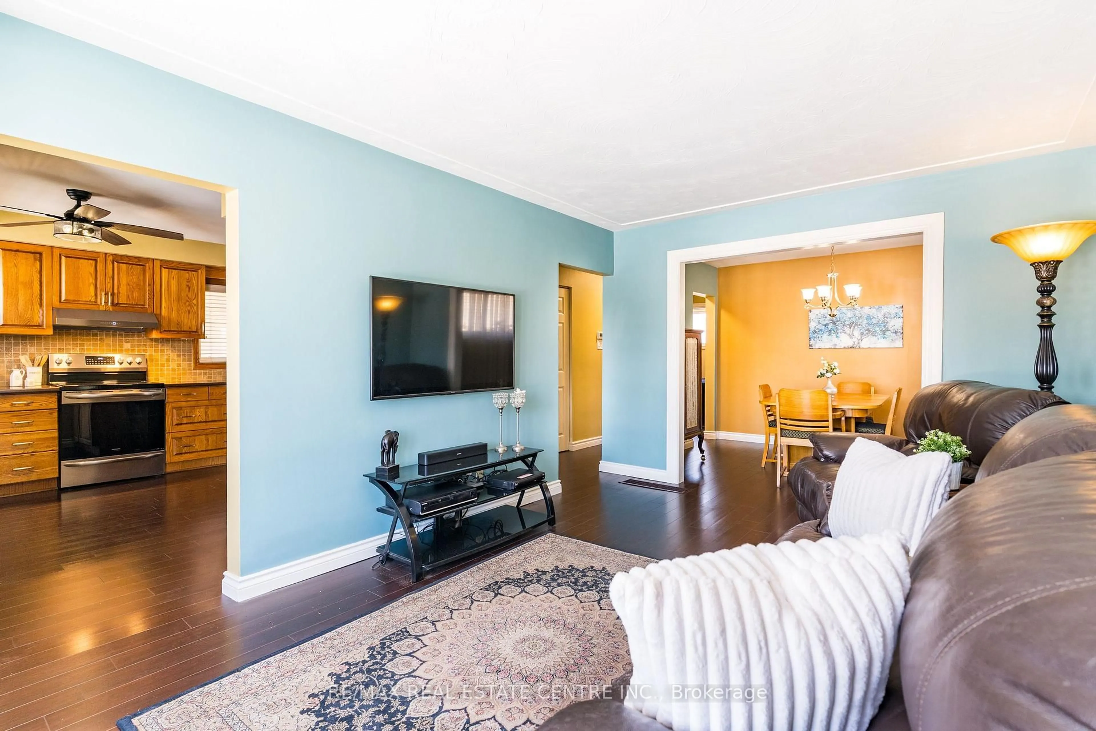 Living room with furniture, wood/laminate floor for 102 Greeningdon Dr, Hamilton Ontario L9A 3A7