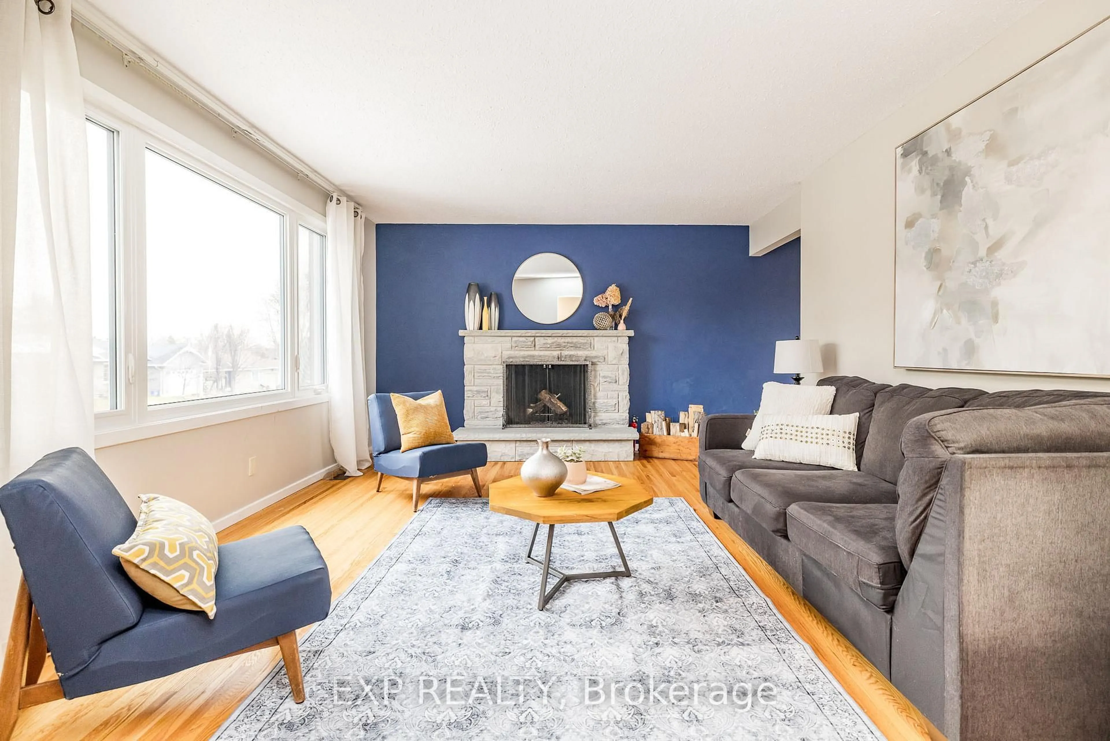 Living room with furniture, wood/laminate floor for 130 Banning Rd, Kanata Ontario K2L 1C4