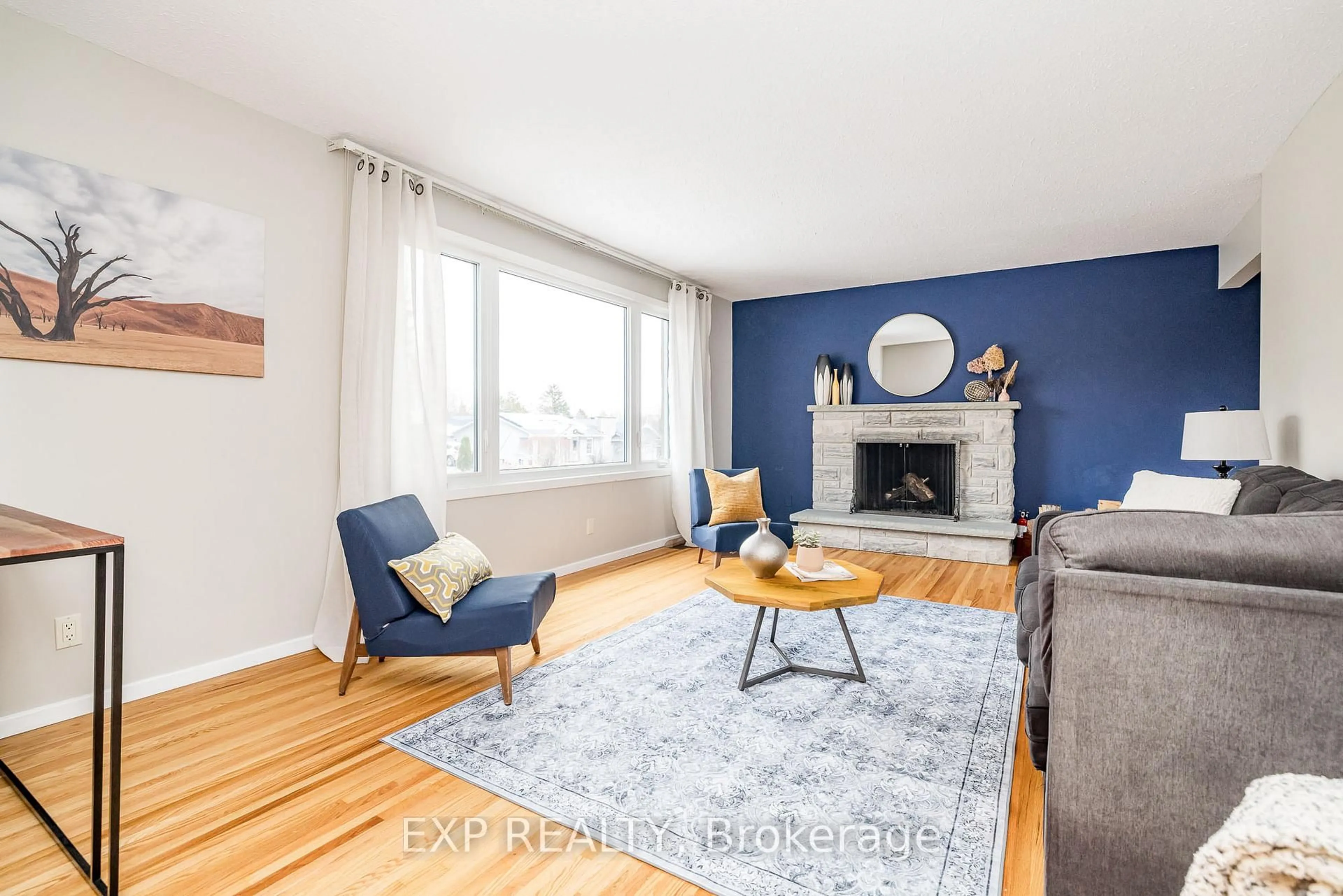 Living room with furniture, wood/laminate floor for 130 Banning Rd, Kanata Ontario K2L 1C4