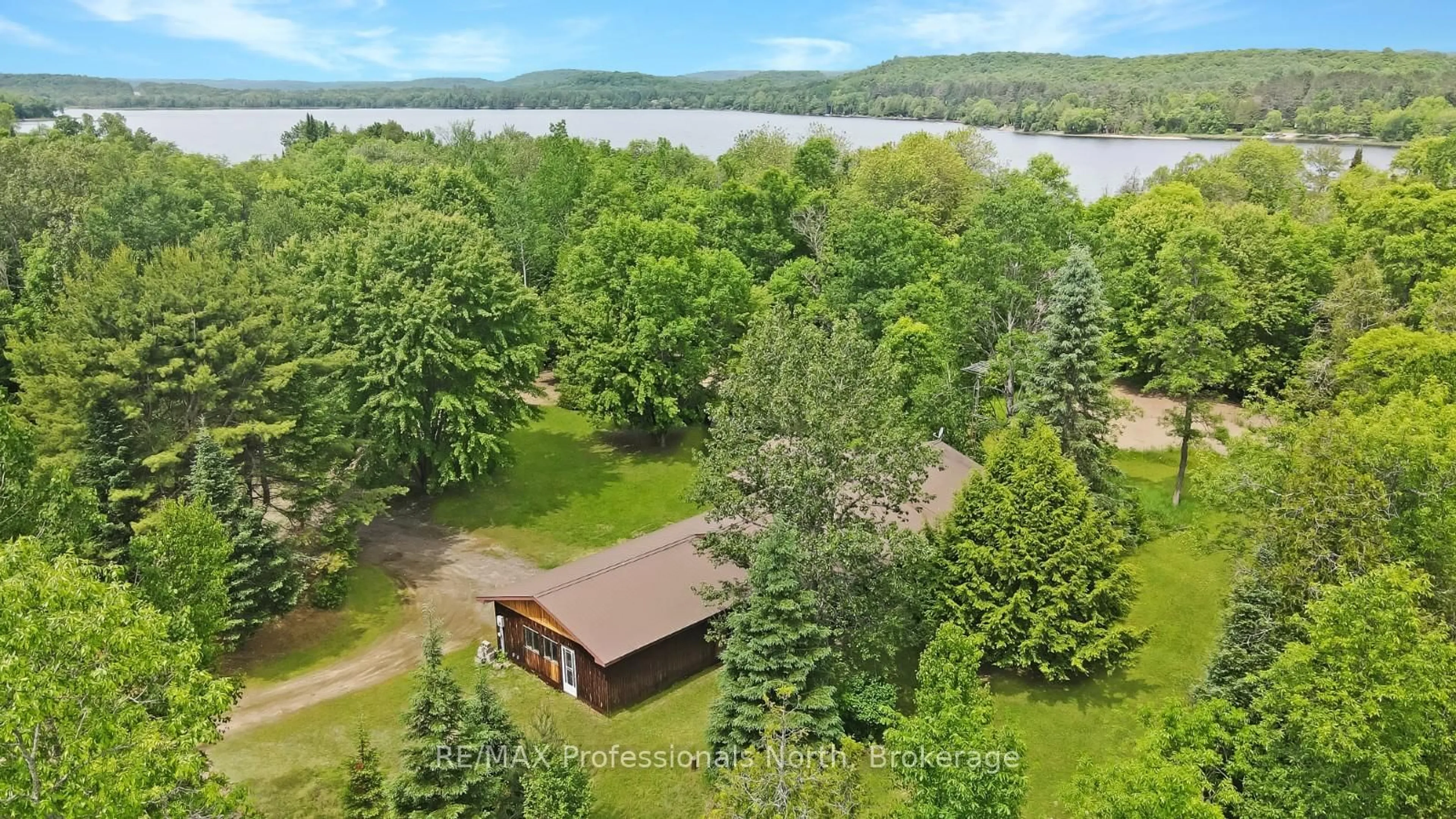 A pic from outside/outdoor area/front of a property/back of a property/a pic from drone, water/lake/river/ocean view for 11601 Highway 118 Highway, Dysart et al Ontario K0M 1S0