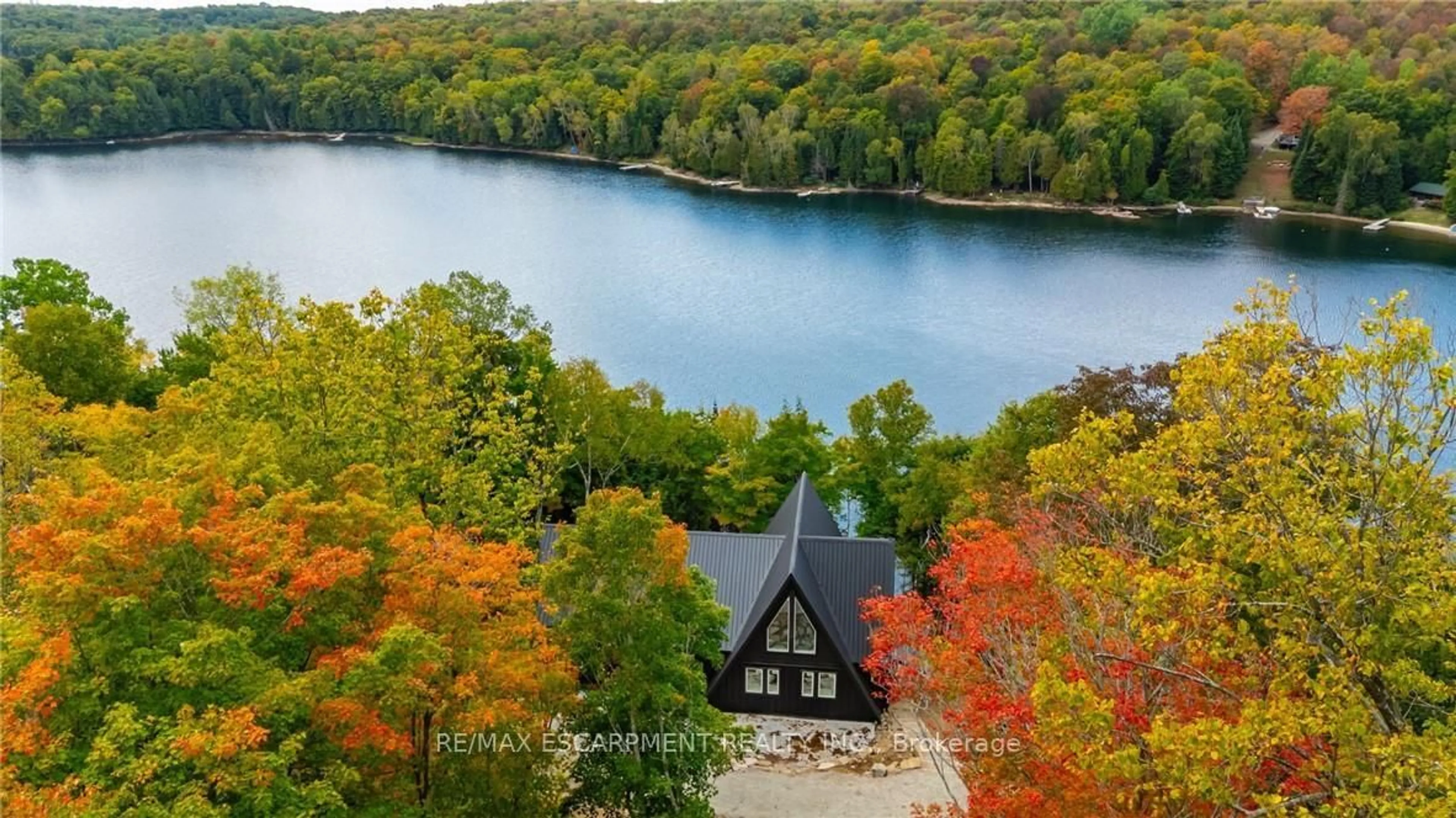 A pic from outside/outdoor area/front of a property/back of a property/a pic from drone, water/lake/river/ocean view for 1295 Wenona Lake Rd, Dysart et al Ontario K0M 1S0