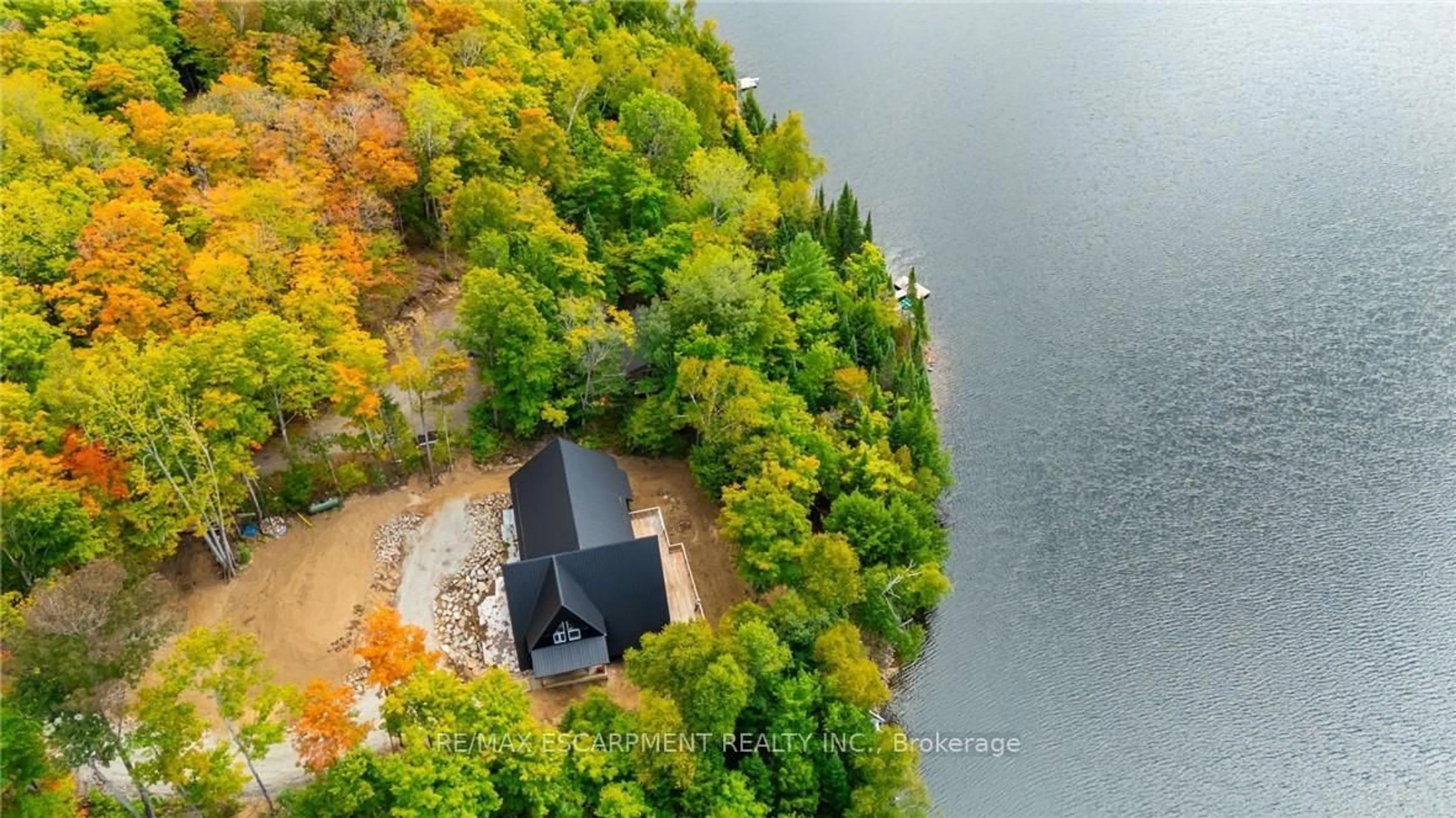 A pic from outside/outdoor area/front of a property/back of a property/a pic from drone, water/lake/river/ocean view for 1295 Wenona Lake Rd, Dysart et al Ontario K0M 1S0