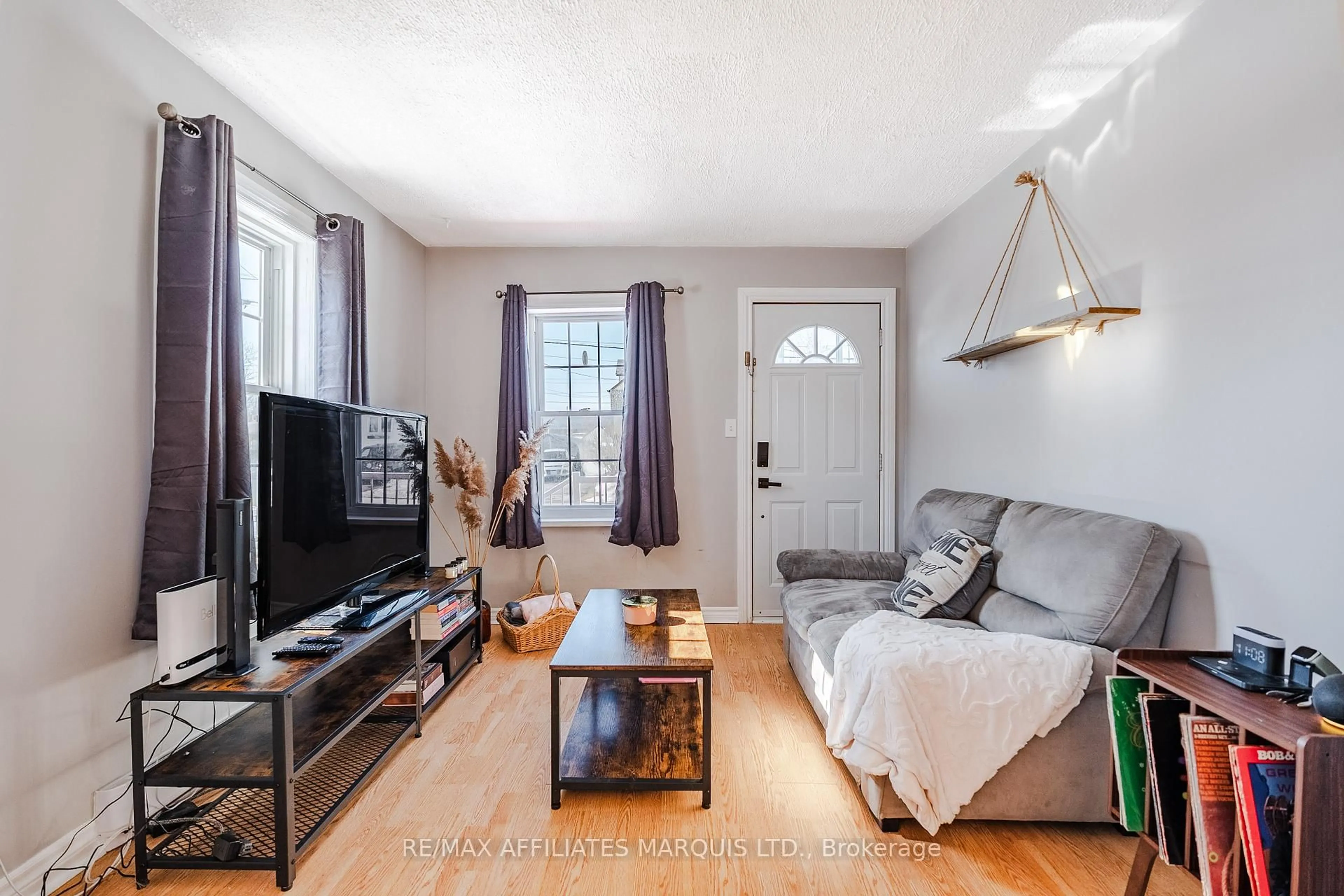 Living room with furniture, wood/laminate floor for 931 Adolphus St, Cornwall Ontario K6H 3T8