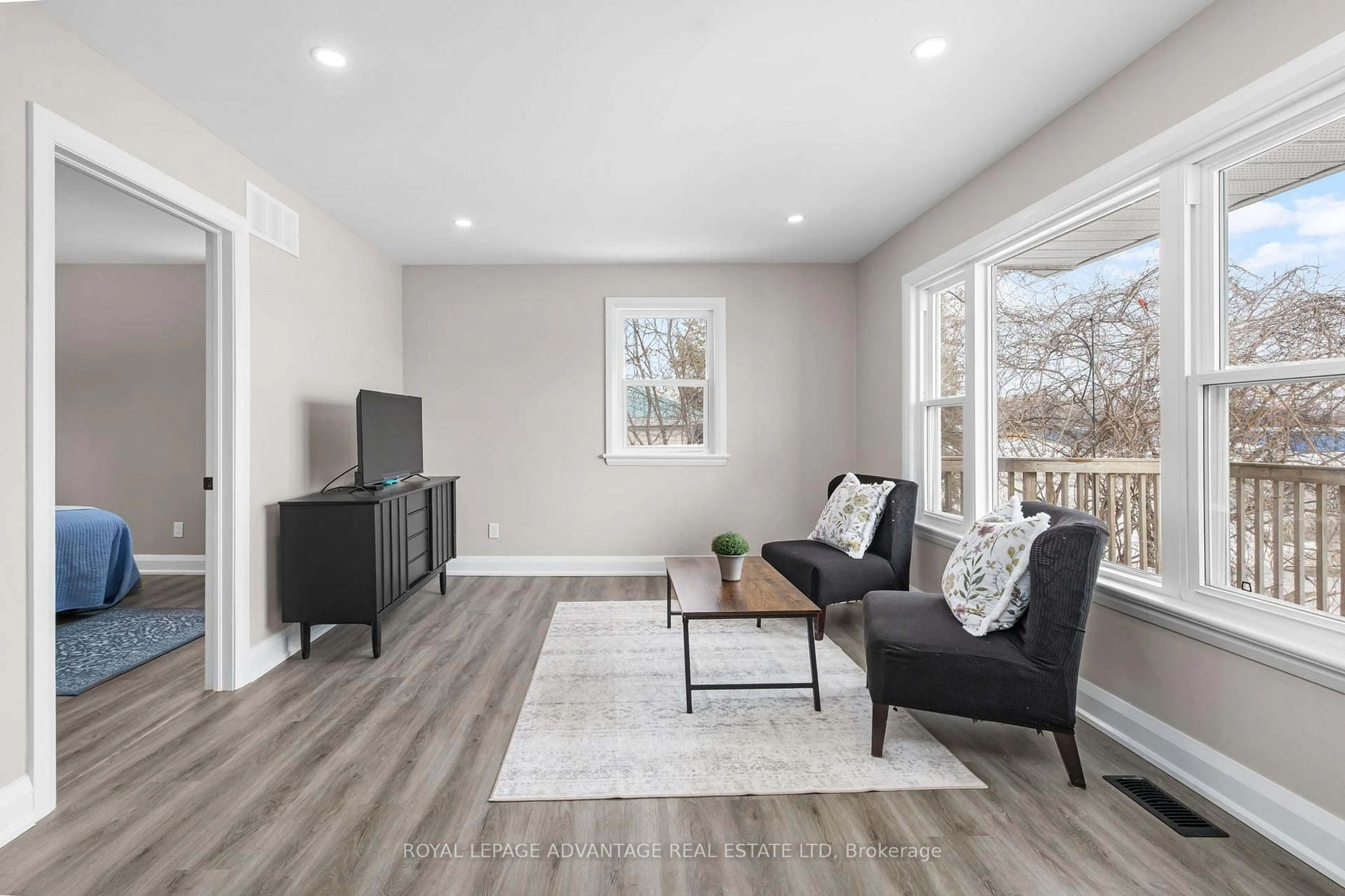 Living room with furniture, wood/laminate floor for 7510 Roger Stevens Dr, Smiths Falls Ontario K7A 4X9
