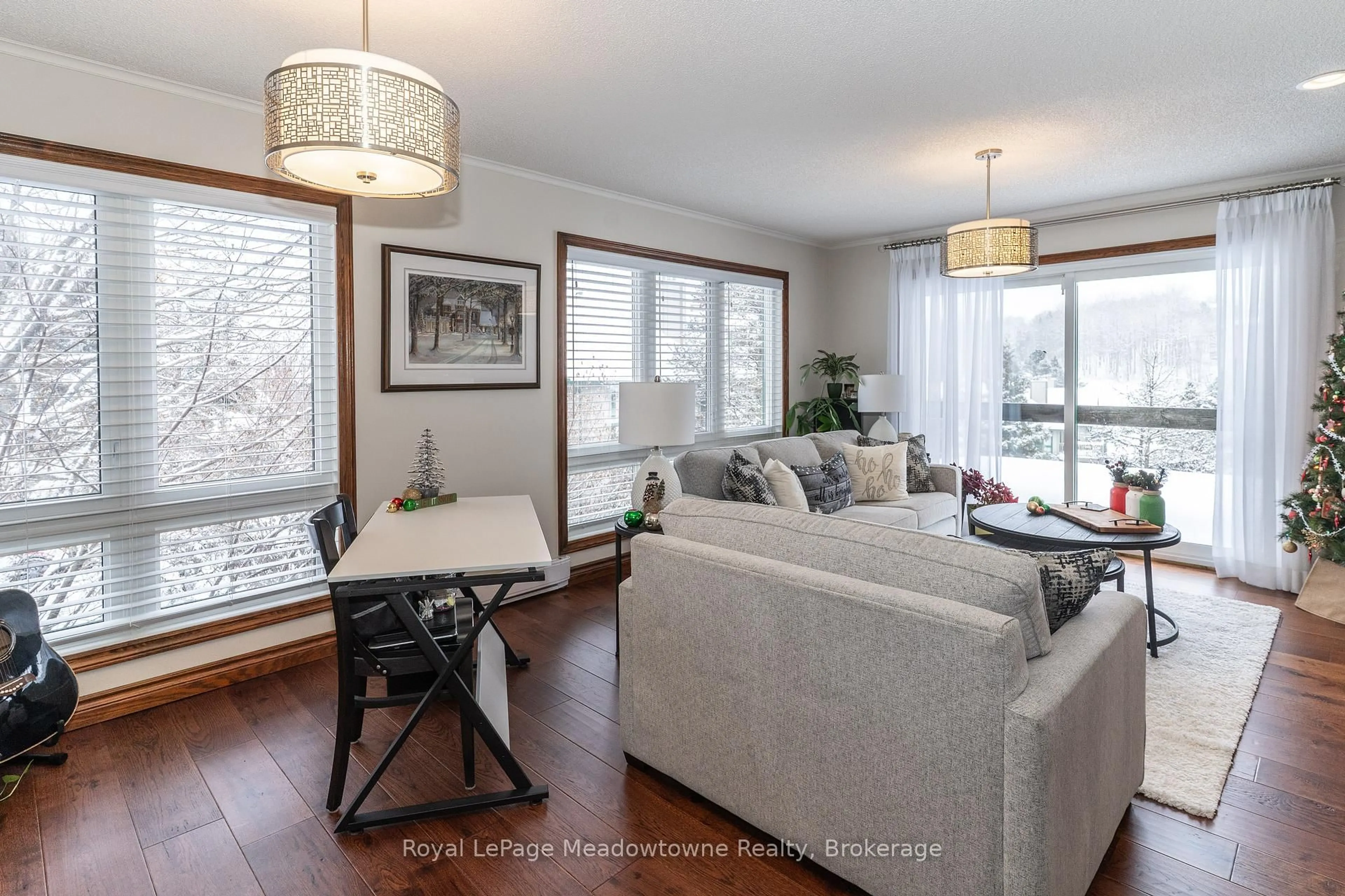 Living room with furniture, wood/laminate floor for 34 Deerhurst Greens Rd #301, Huntsville Ontario P1H 1A9