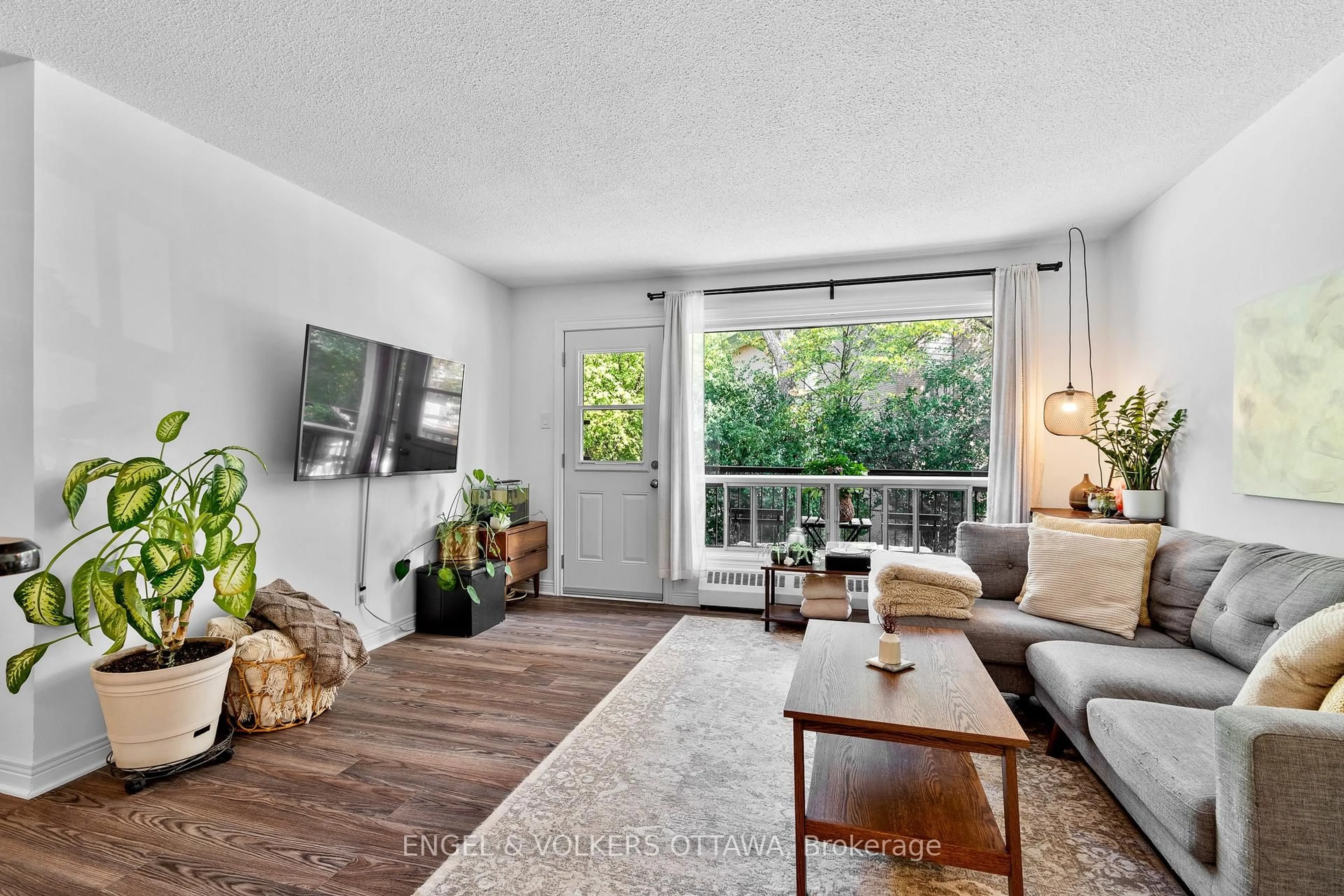 Living room with furniture, wood/laminate floor for 270 Beechwood Ave #11, Ottawa Ontario K1L 8A6