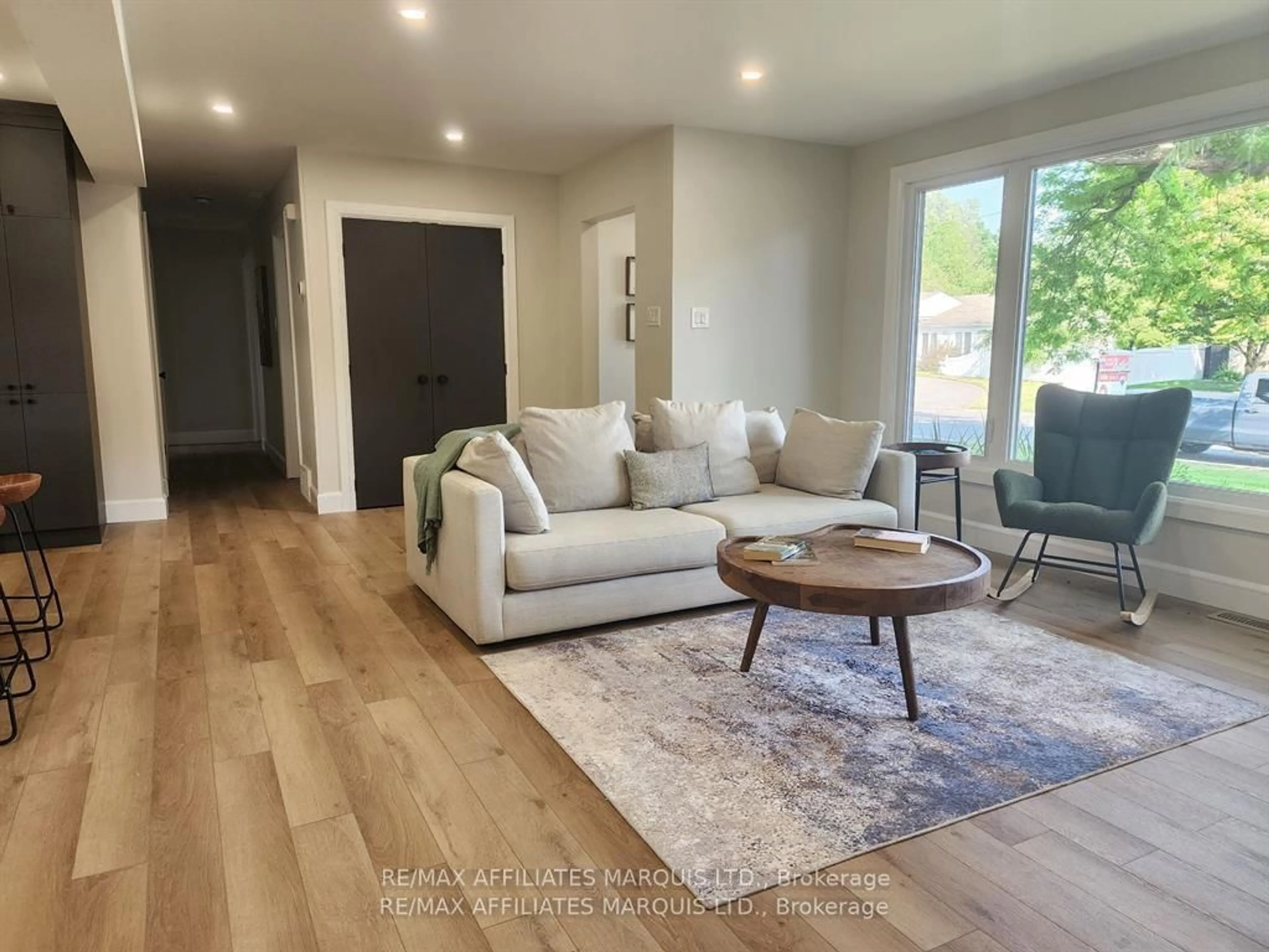 Living room with furniture, wood/laminate floor for 1409 Leonard Ave, Cornwall Ontario K6J 1M9