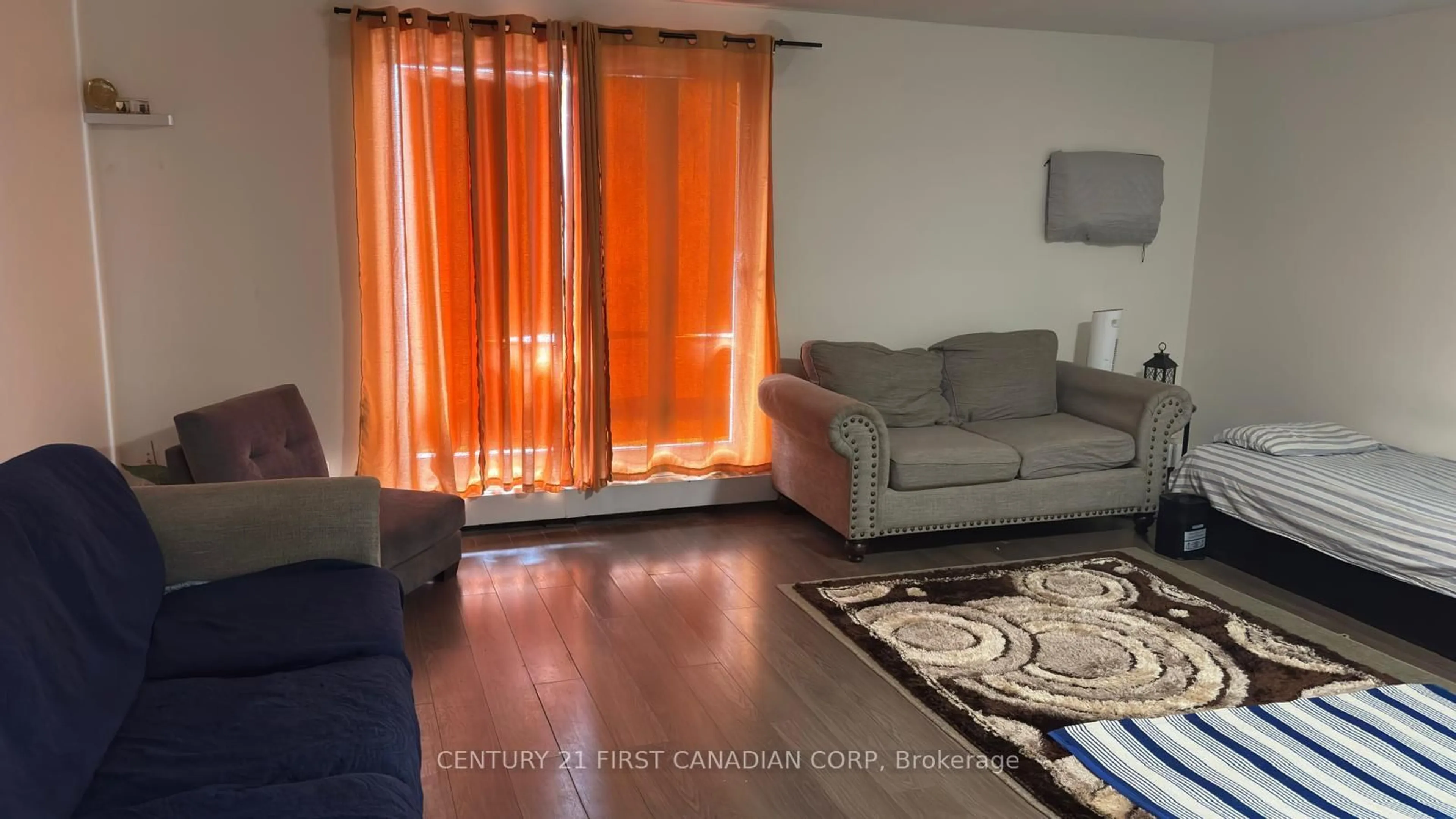 Living room with furniture, wood/laminate floor for 573 Mornington Ave #210, London East Ontario N5Y 4T9