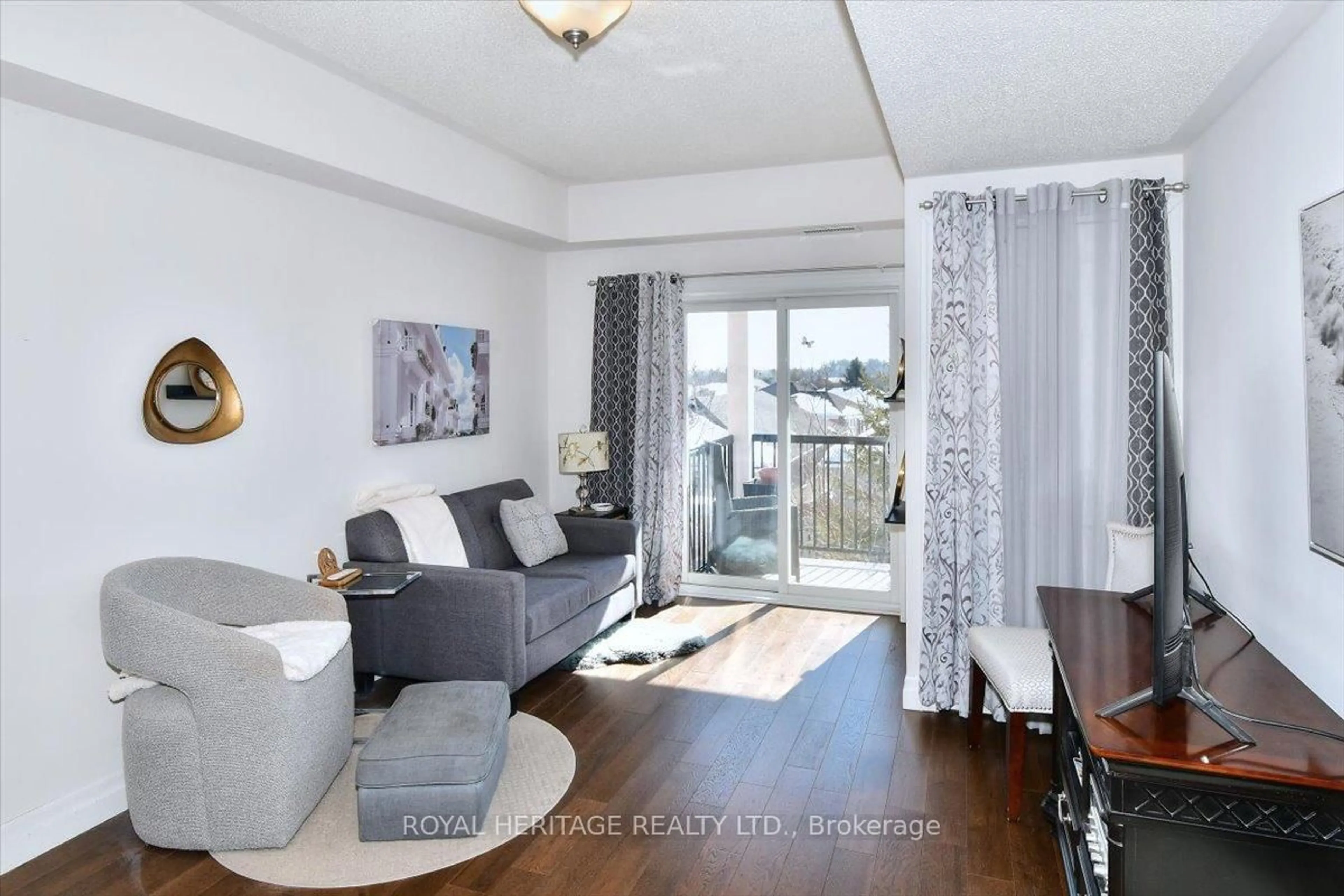 Living room with furniture, wood/laminate floor for 910 Wentworth St #204, Peterborough Ontario K9J 8R8