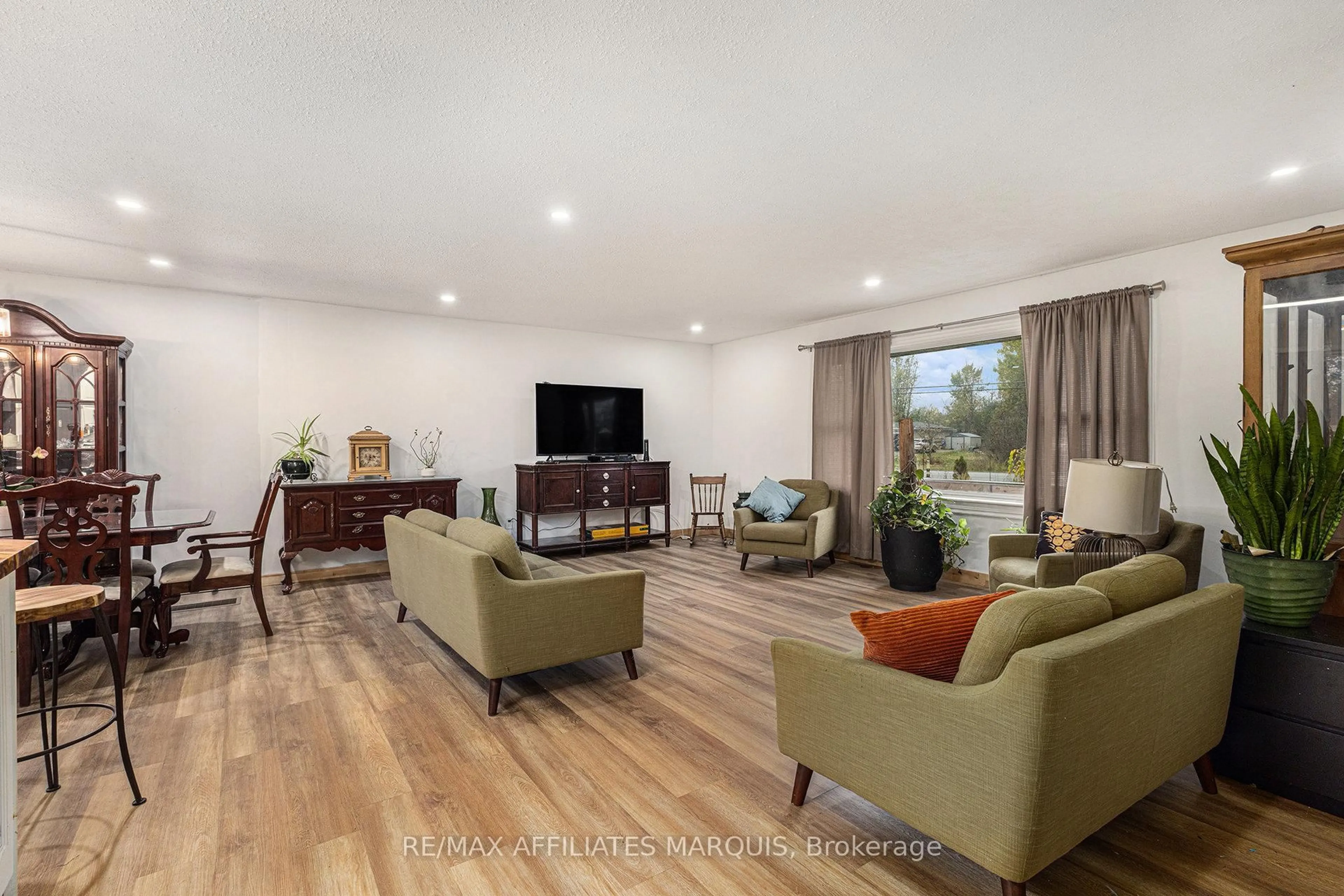 Living room with furniture, wood/laminate floor for 7349 Roger Stevens Dr, Smiths Falls Ontario K7A 4S6