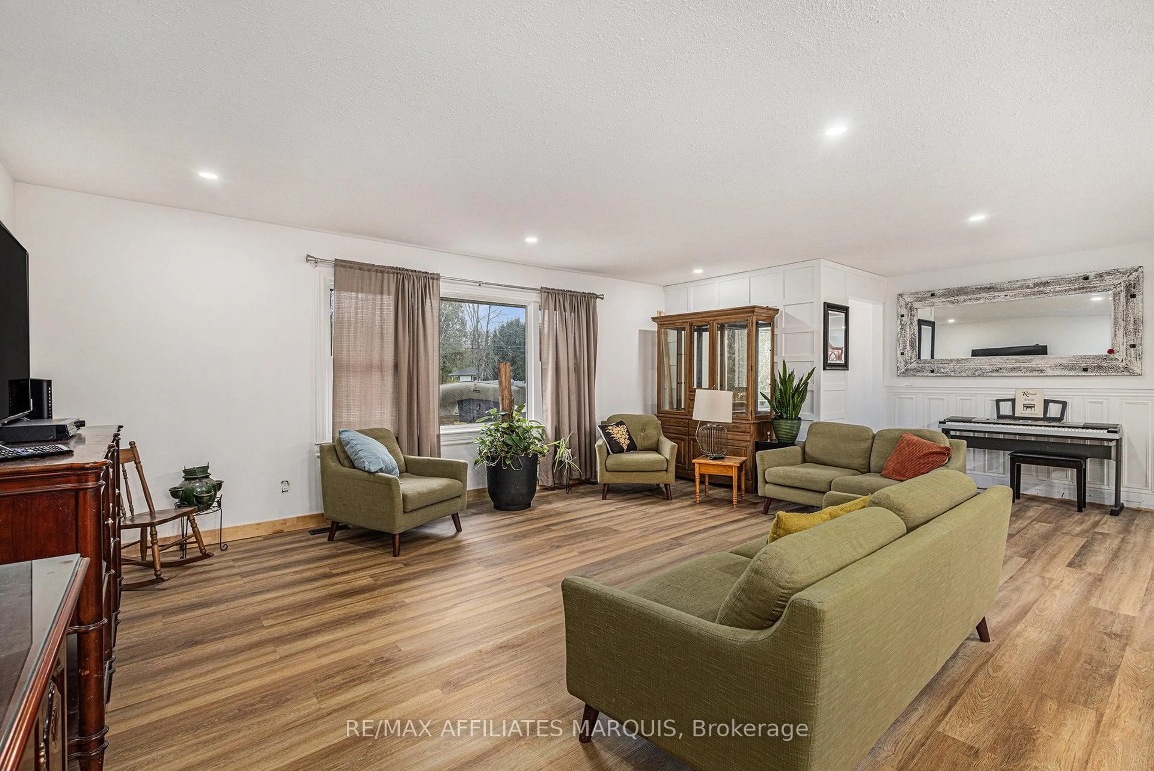 Living room with furniture, wood/laminate floor for 7349 Roger Stevens Dr, Smiths Falls Ontario K7A 4S6