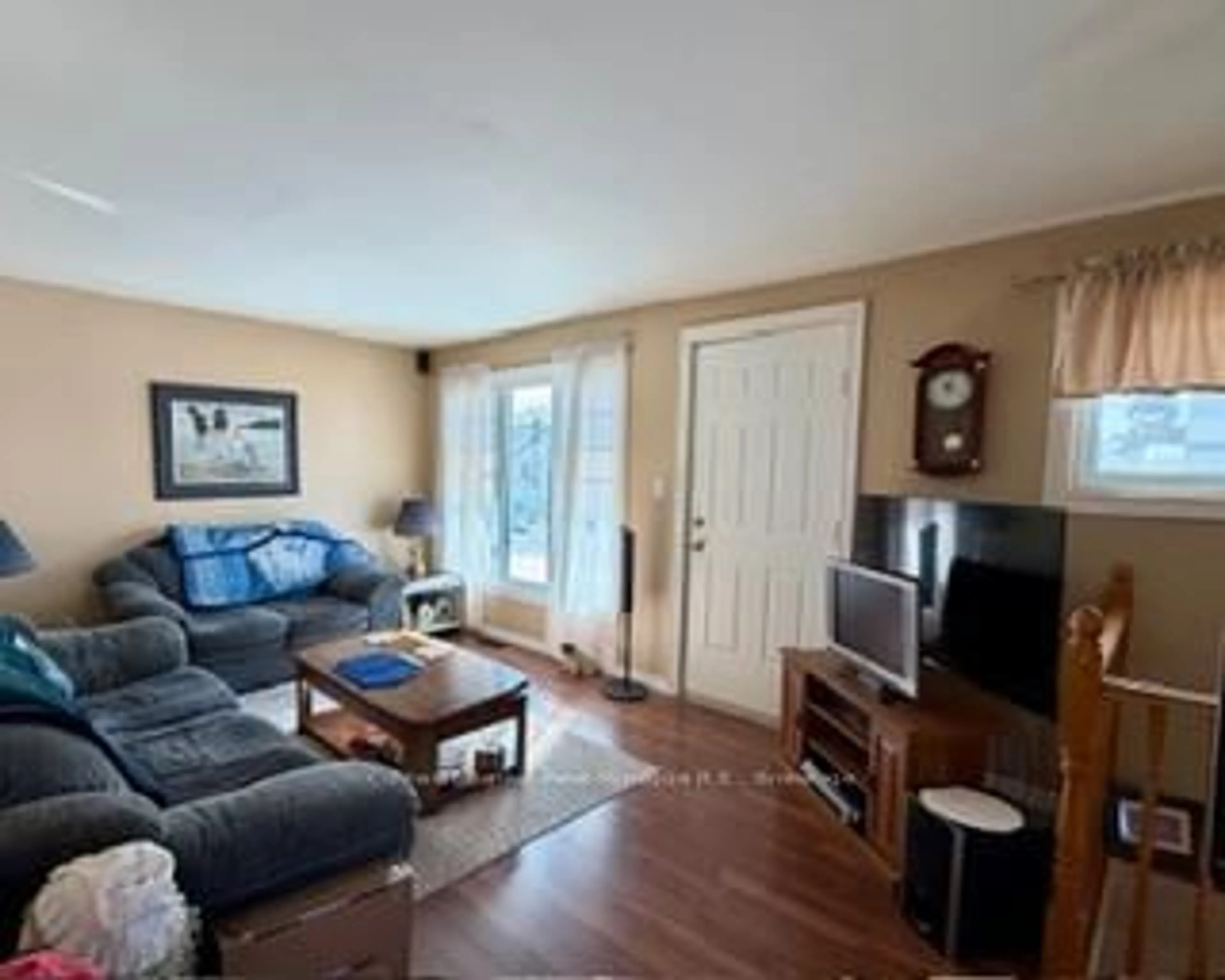 Living room with furniture, wood/laminate floor for 310 Gould Ave, North Bay Ontario P1B 7C8