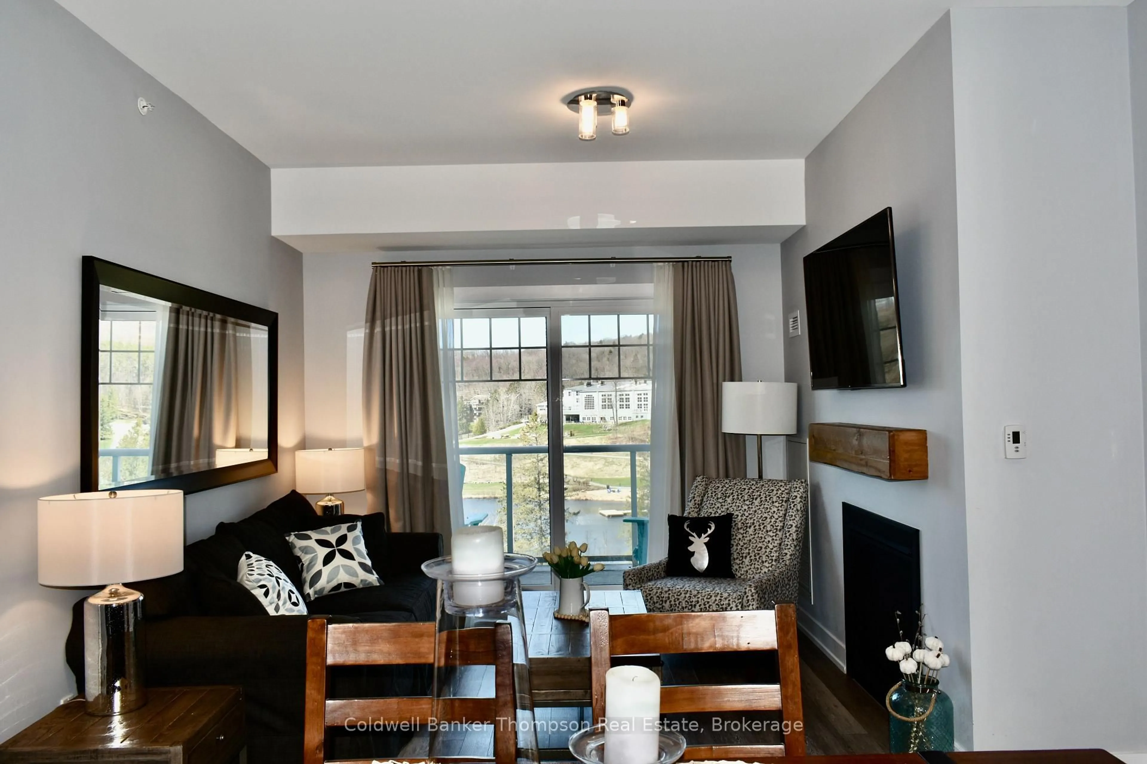 Living room with furniture, wood/laminate floor for 25 PEN LAKE POINT Rd #404, Huntsville Ontario P1H 1A9