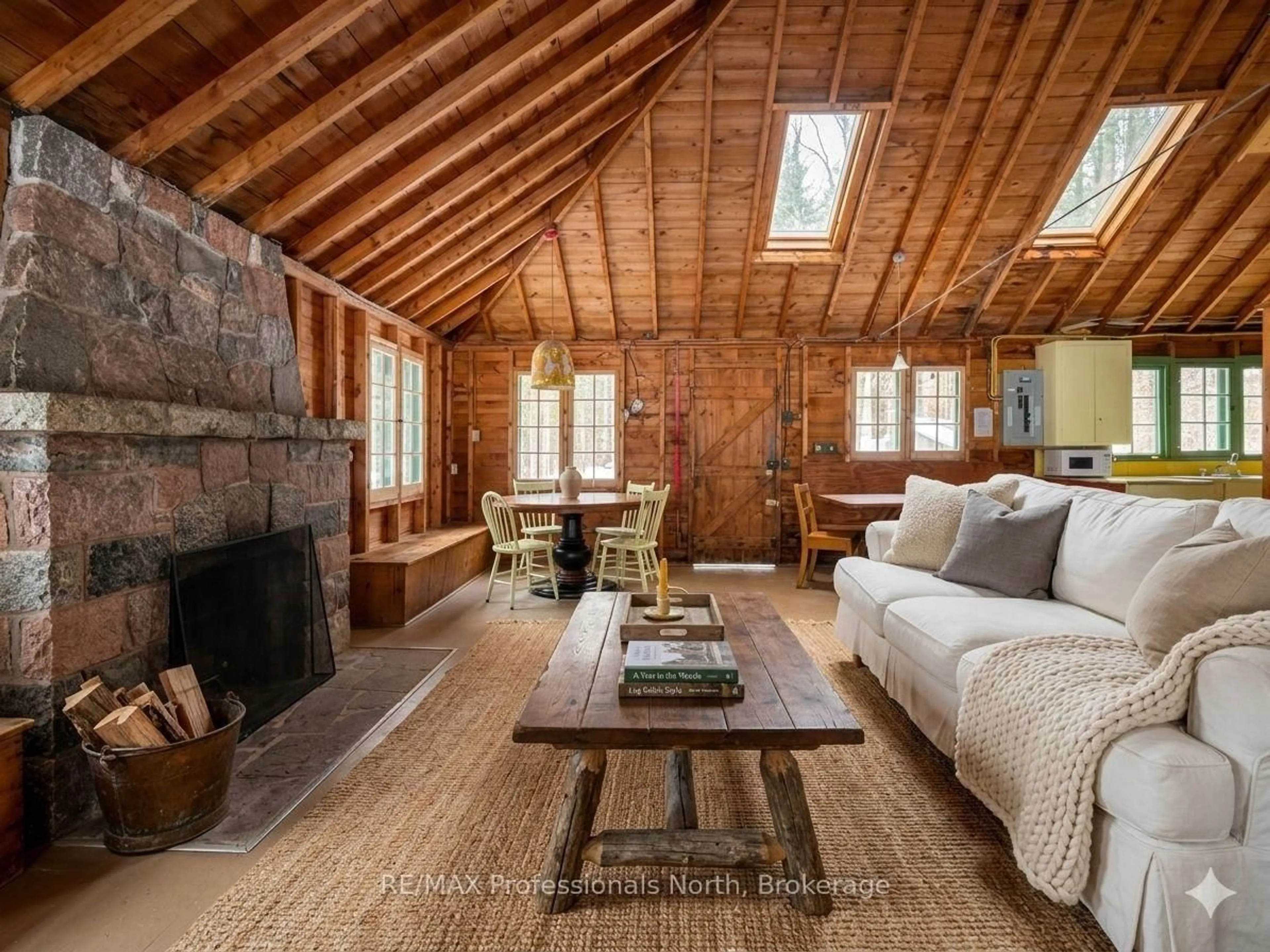 Living room with furniture, wood/laminate floor for 1005 Deacons Tr, Algonquin Highlands Ontario K0M 1J2
