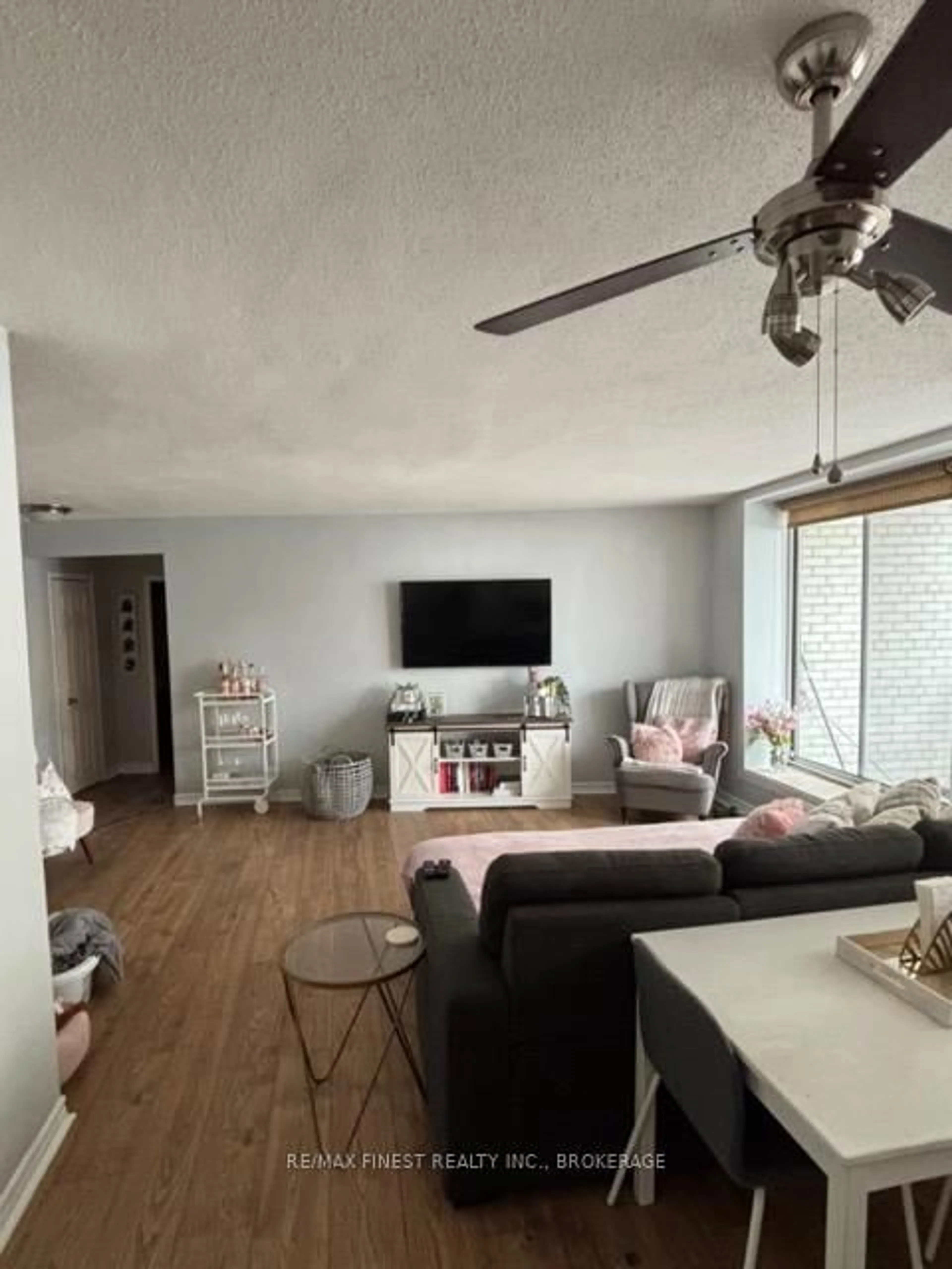 Living room with furniture, wood/laminate floor for 1 Mowat Ave #106, Kingston Ontario K7M 1J8
