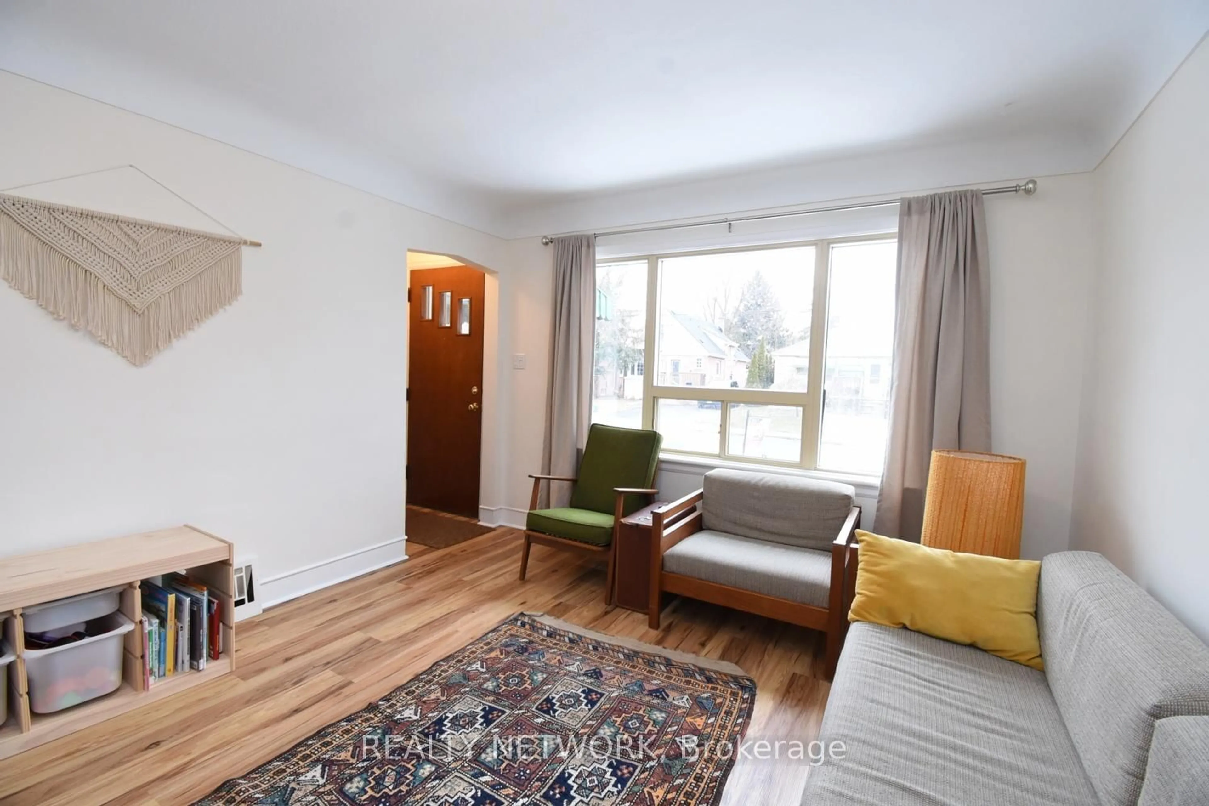 Living room with furniture, wood/laminate floor for 60 Maclennan Ave, Hamilton Ontario L8V 1X4