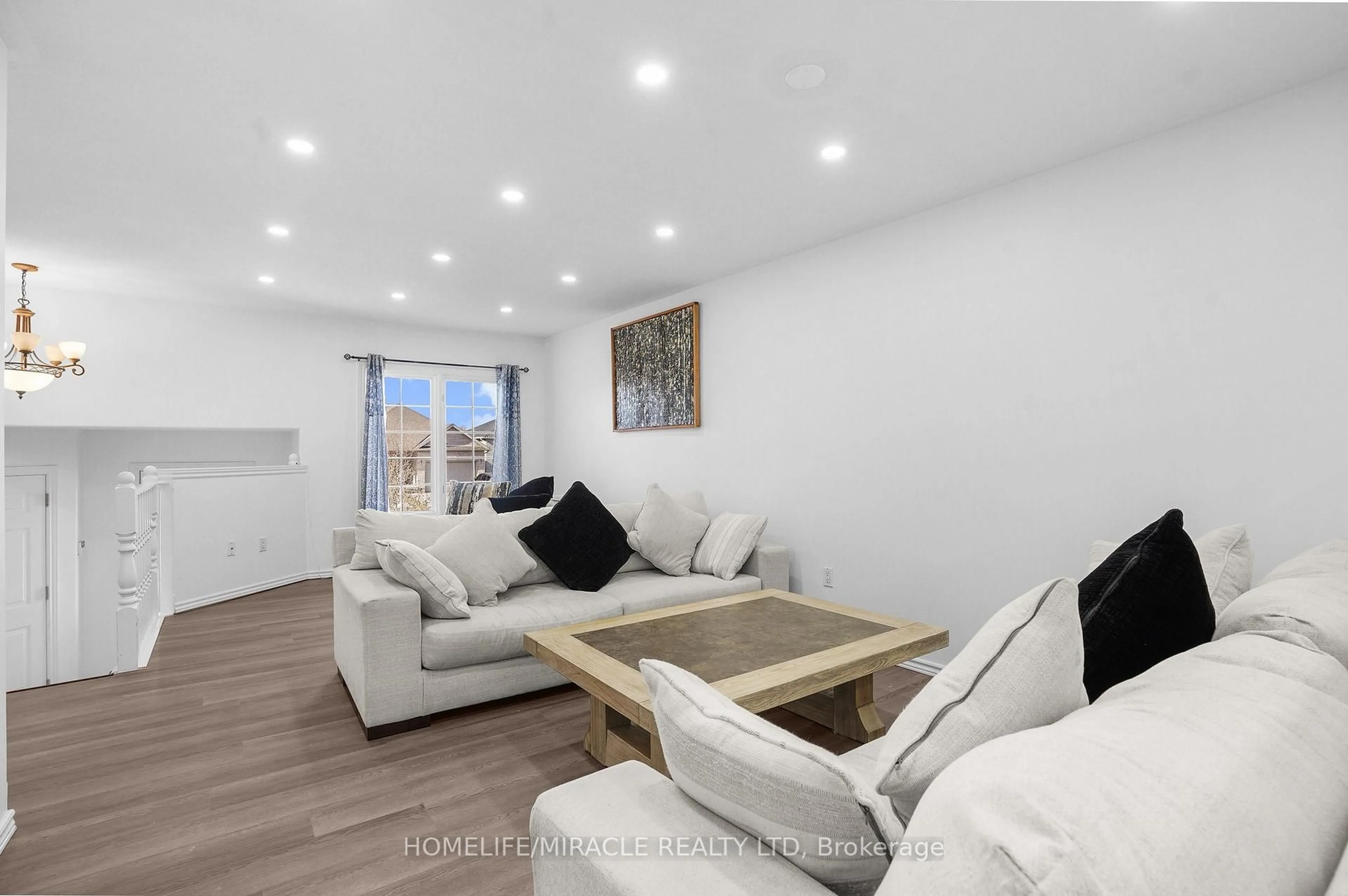 Living room with furniture, wood/laminate floor for 8 Bradley Lane, Brantford Ontario N3T 6R5