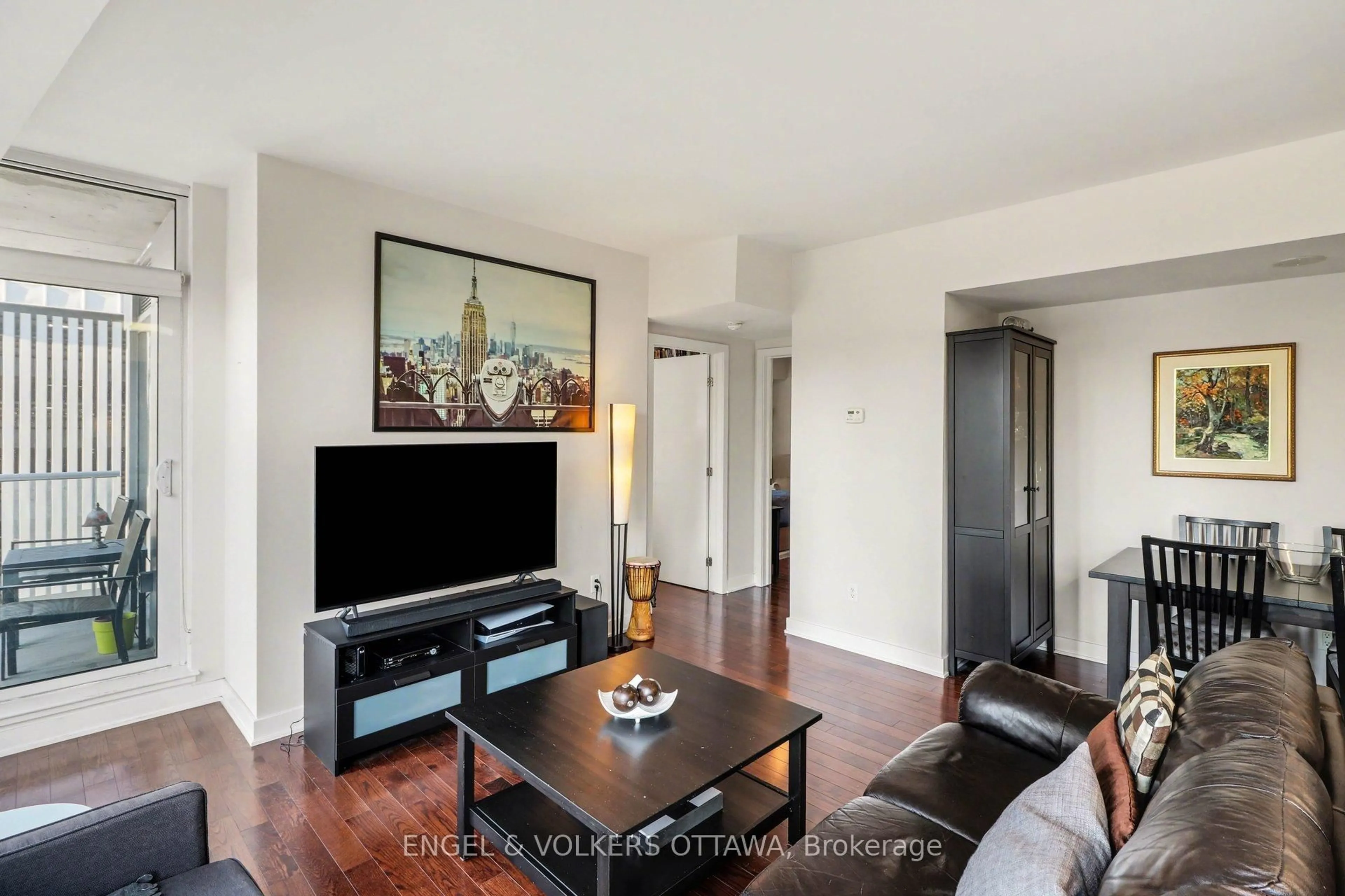 Living room with furniture, wood/laminate floor for 179 Metcalfe St #701, Ottawa Ontario K2P 0W1