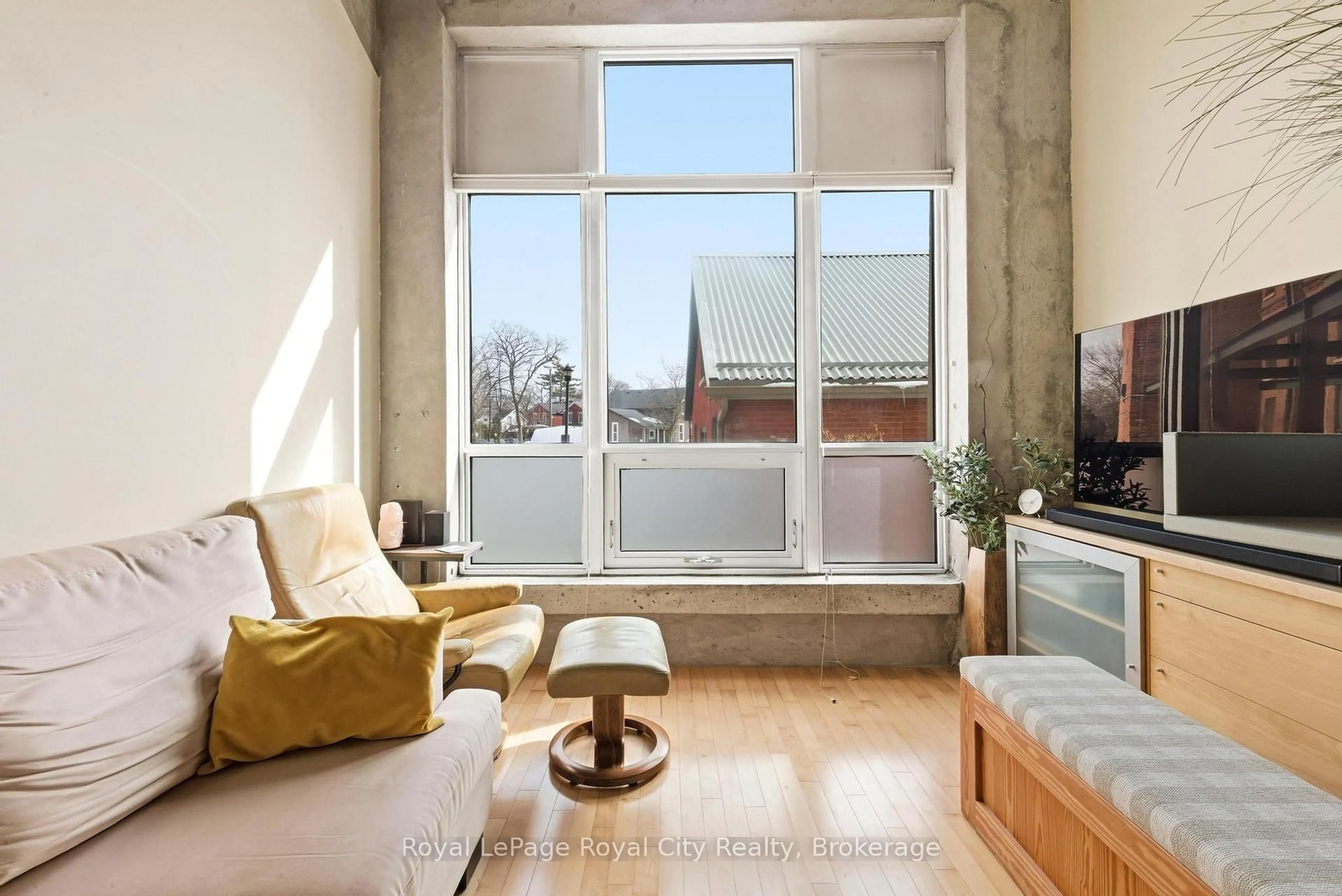 Living room with furniture, cement floor for 26 Ontario St #108, Guelph Ontario N1E 7K1