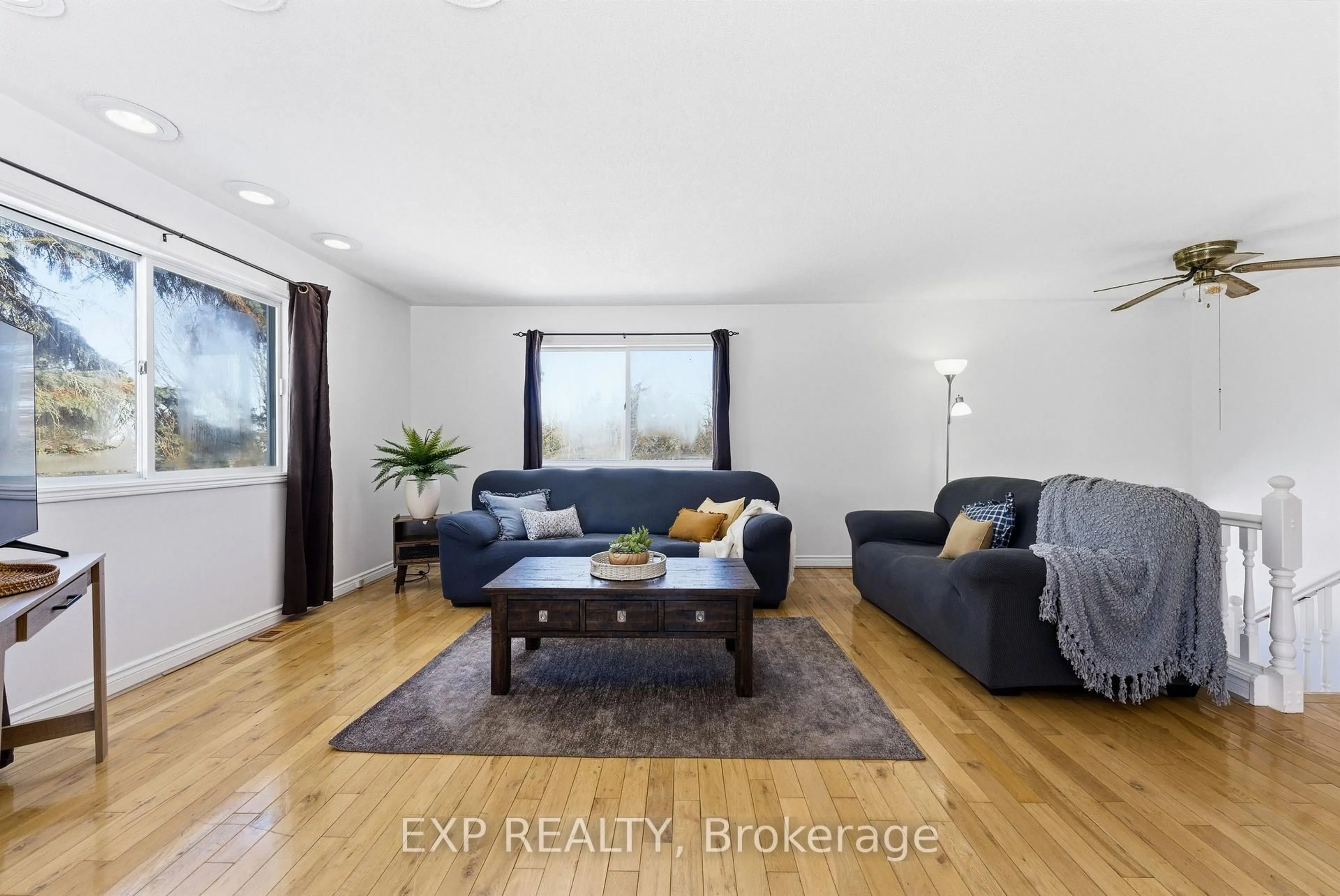 Living room with furniture, wood/laminate floor for 15 Mcintyre Rd, Prince Edward County Ontario K0K 1A0