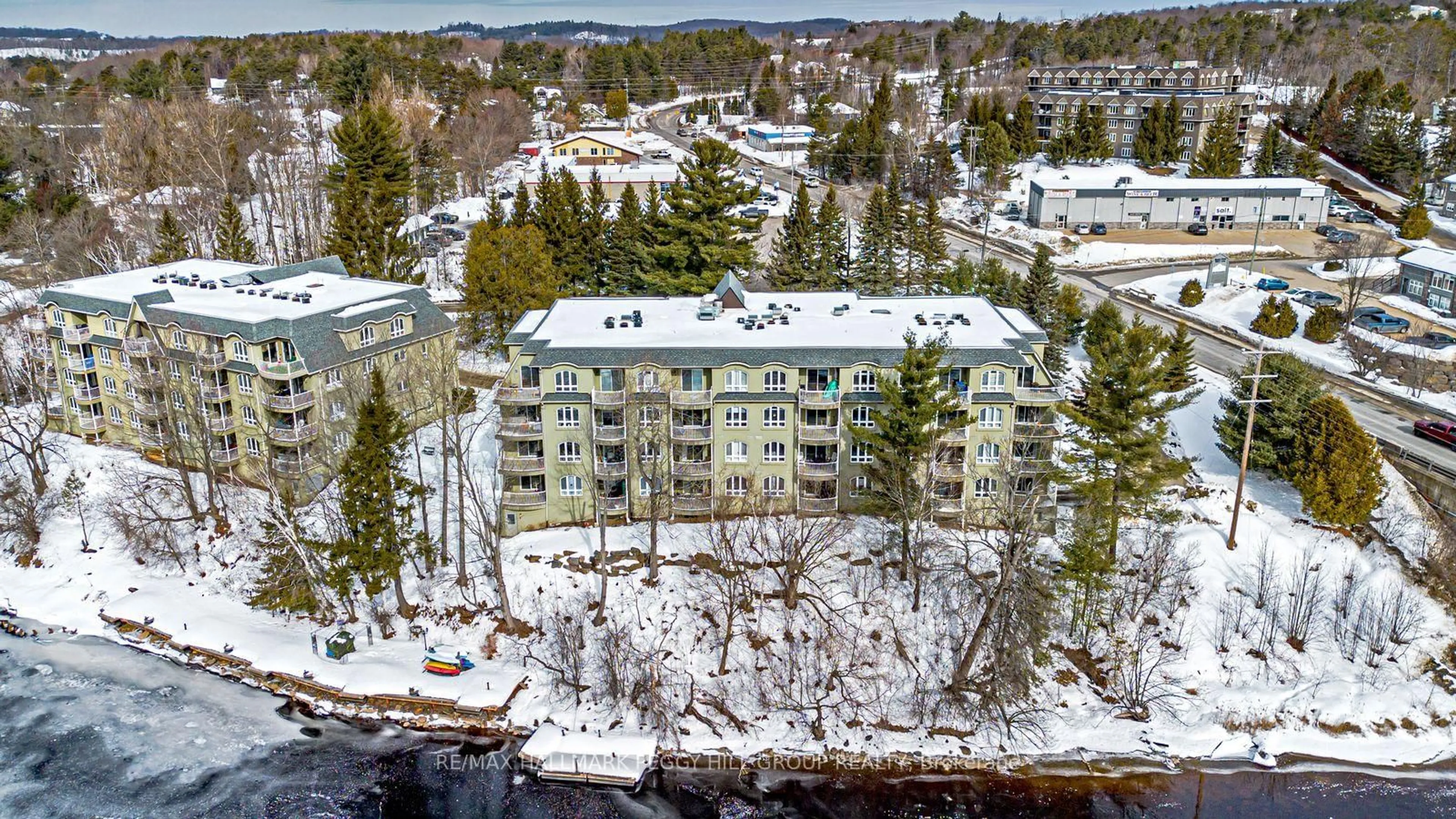 A pic from outside/outdoor area/front of a property/back of a property/a pic from drone, unknown for 31 Dairy Lane #308, Huntsville Ontario P1H 2L7