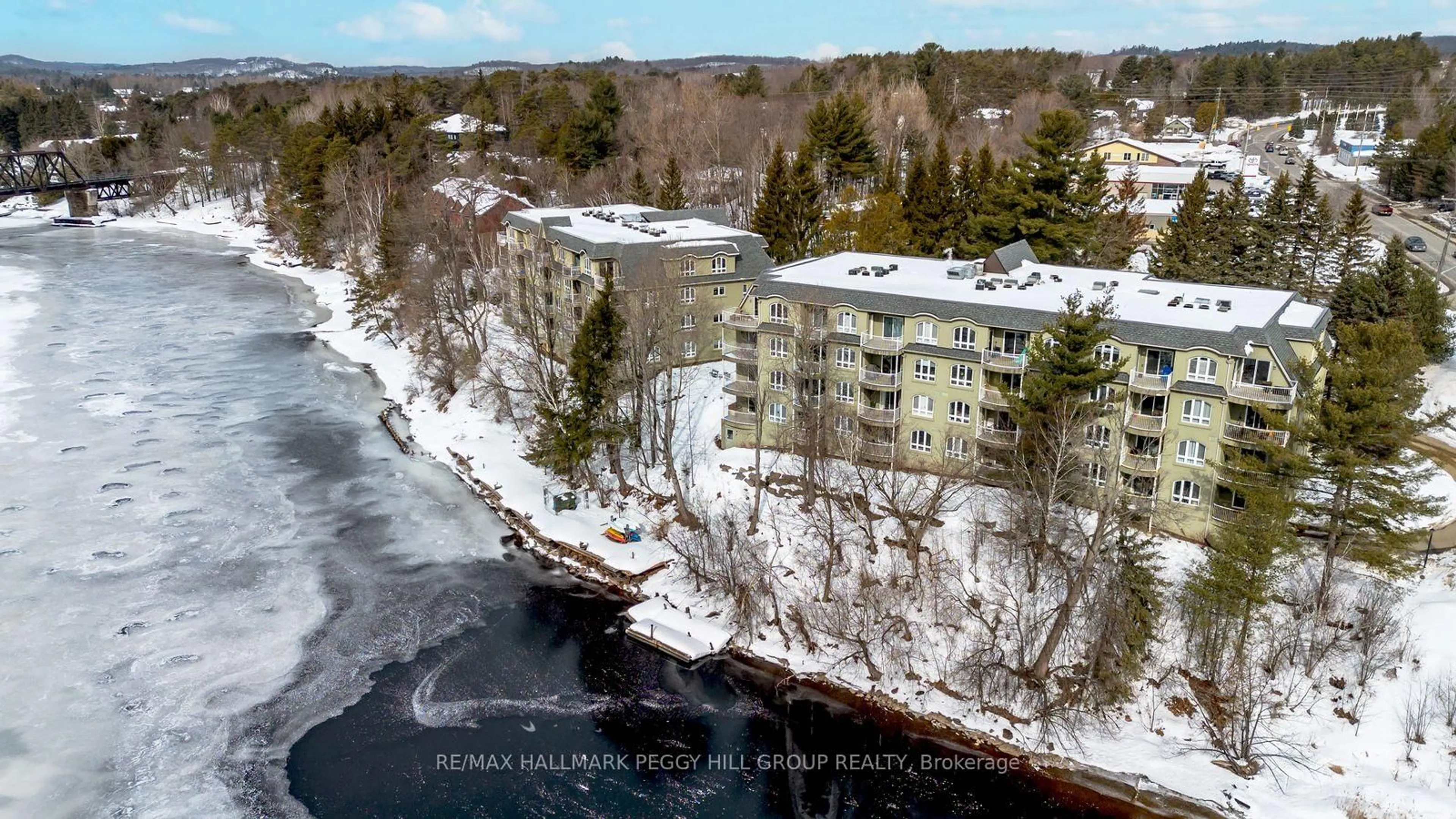 A pic from outside/outdoor area/front of a property/back of a property/a pic from drone, water/lake/river/ocean view for 31 Dairy Lane #308, Huntsville Ontario P1H 2L7