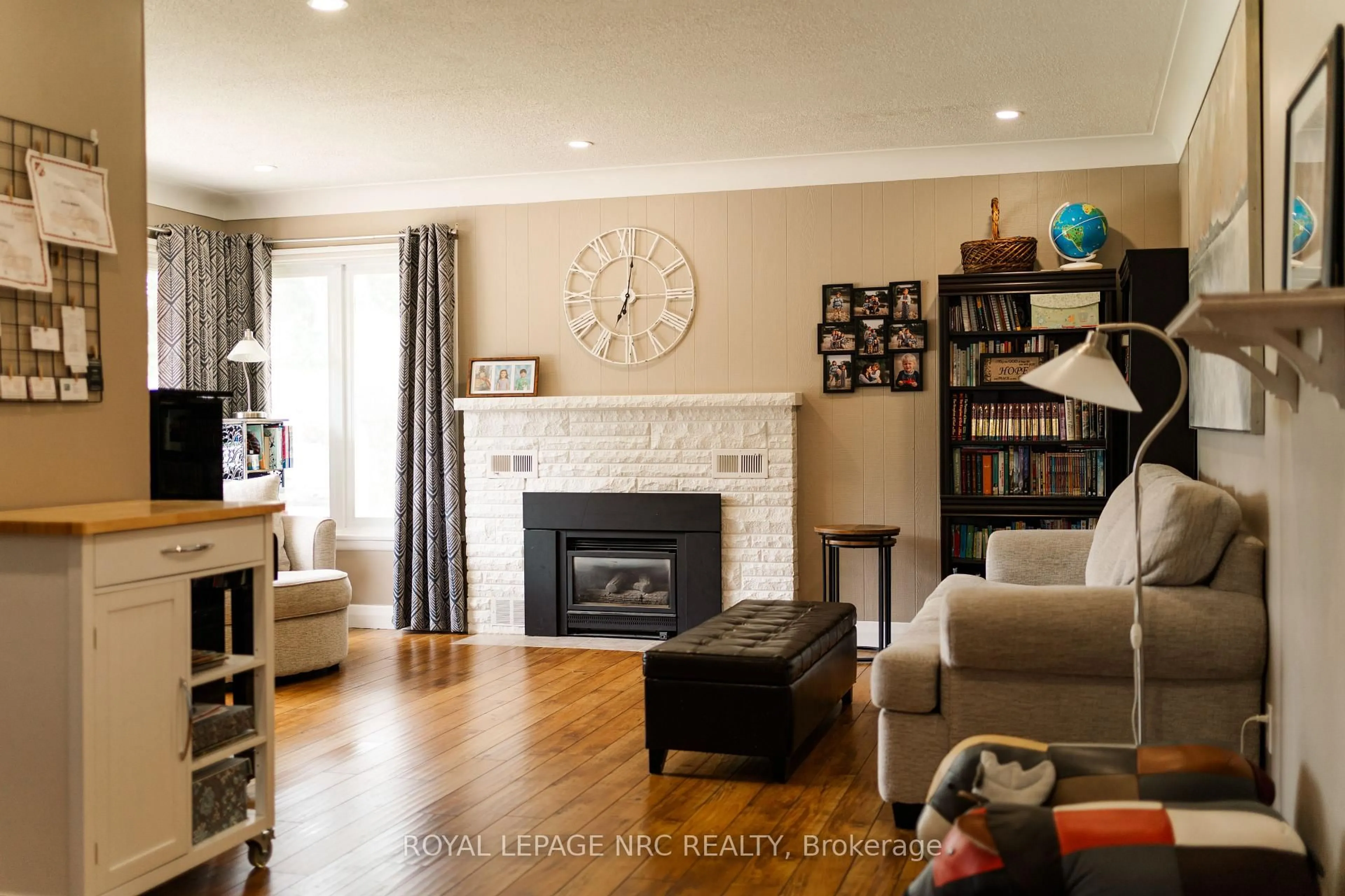 Living room with furniture, wood/laminate floor for 12 Mackie St, St. Catharines Ontario L2N 5N5