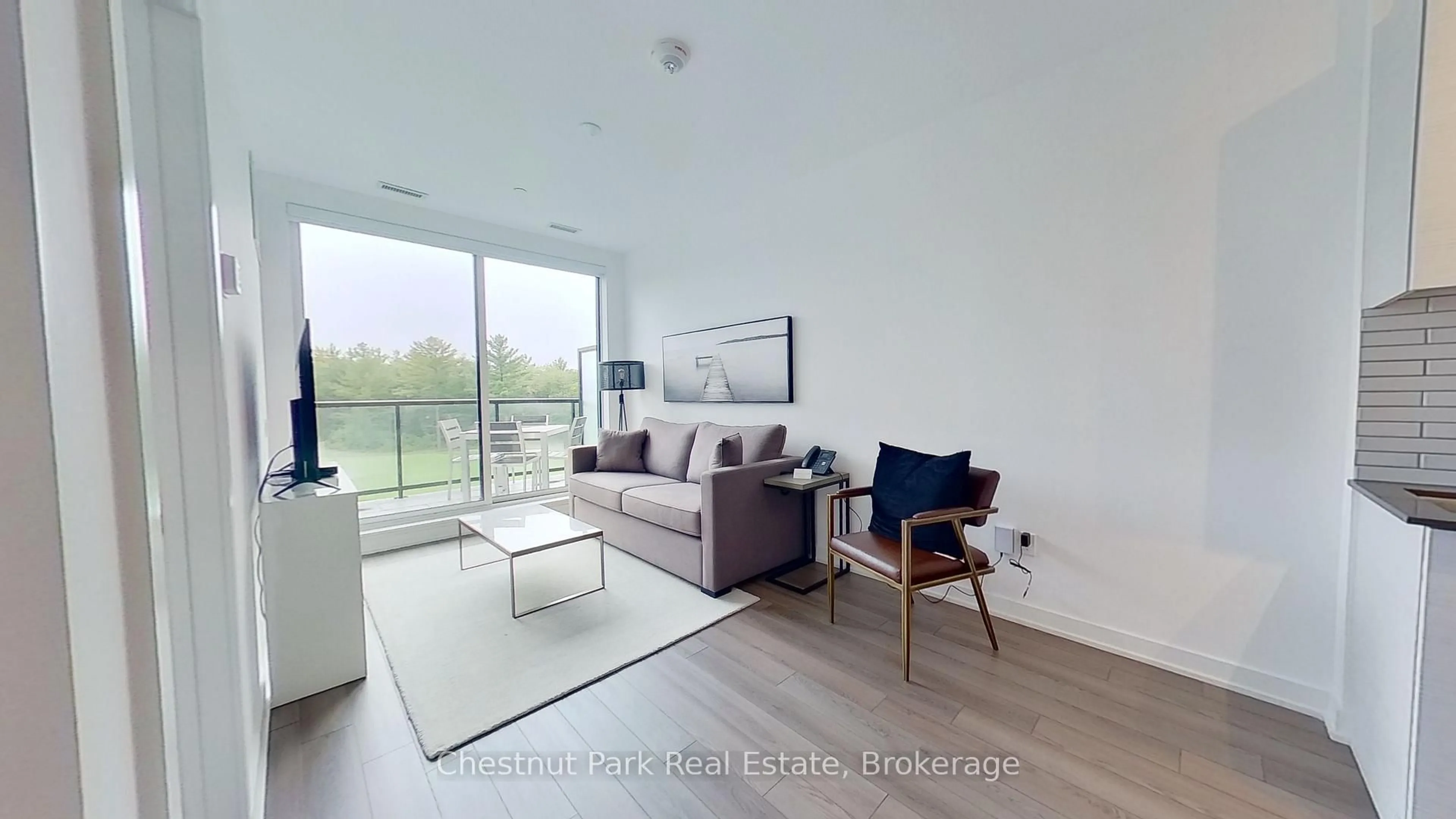 Living room with furniture, wood/laminate floor for 120 Carrick Tr #410, Gravenhurst Ontario P1P 0B6