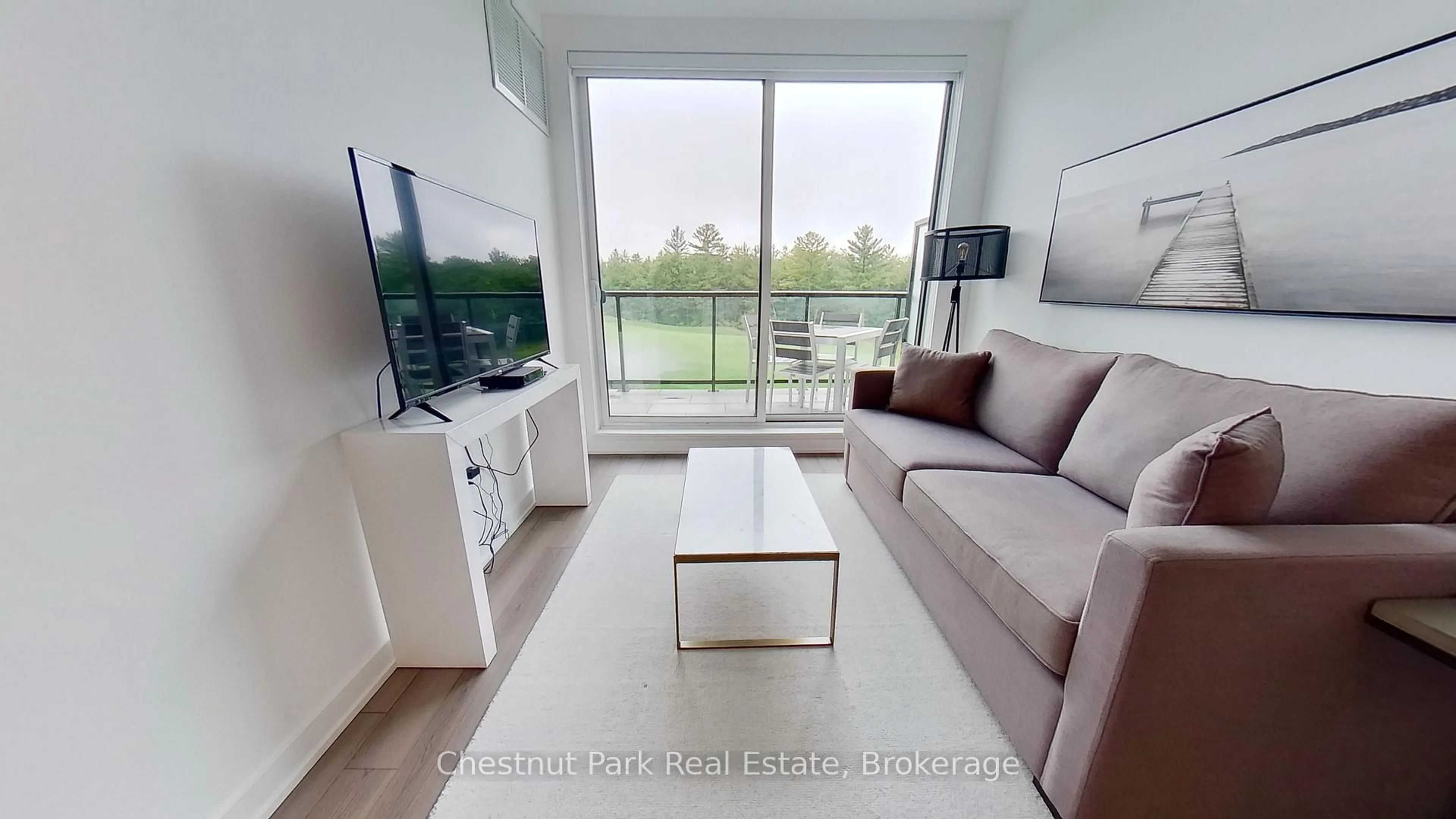 Living room with furniture, wood/laminate floor for 120 Carrick Tr #410, Gravenhurst Ontario P1P 0B6