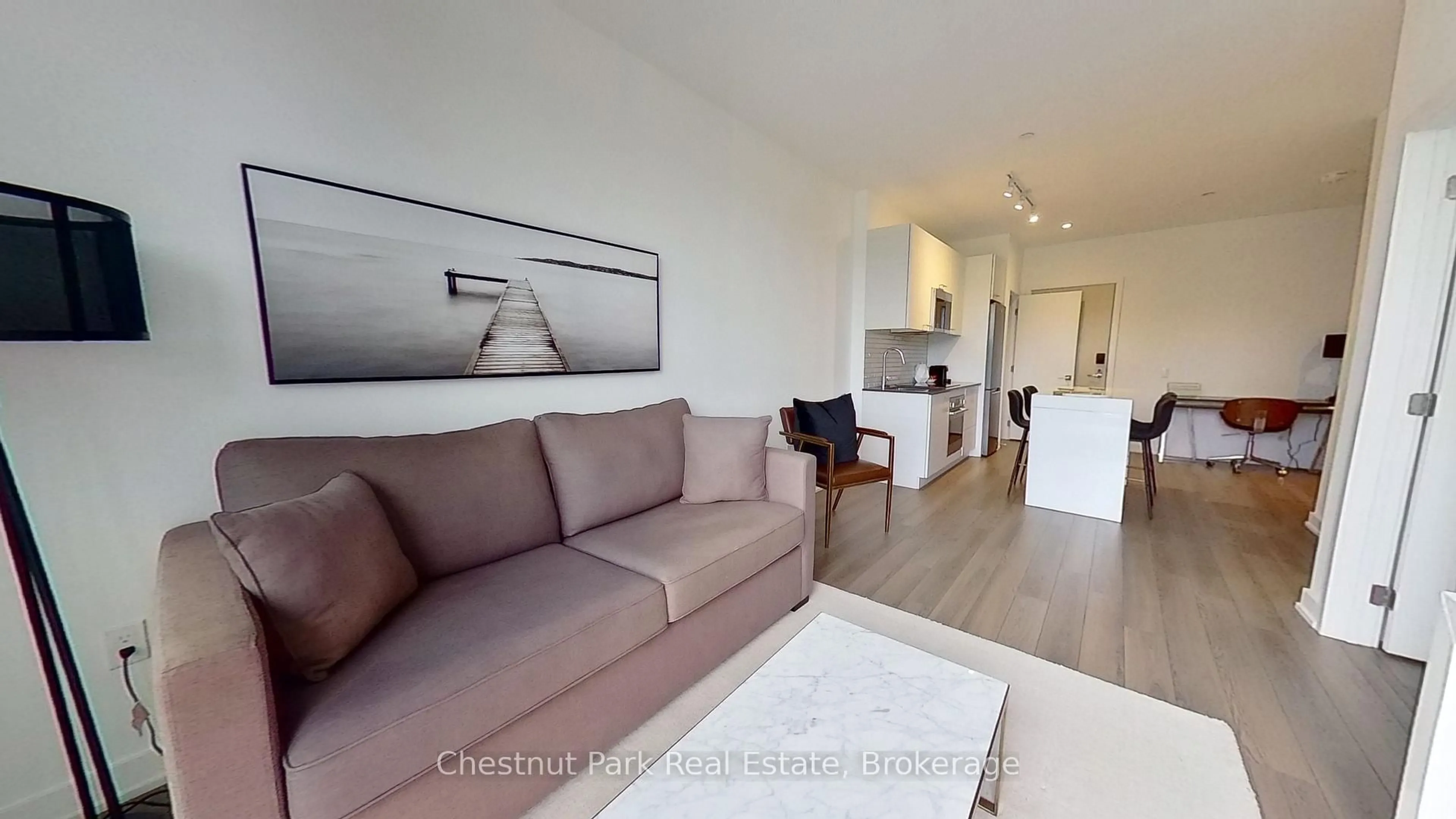 Living room with furniture, wood/laminate floor for 120 Carrick Tr #410, Gravenhurst Ontario P1P 0B6