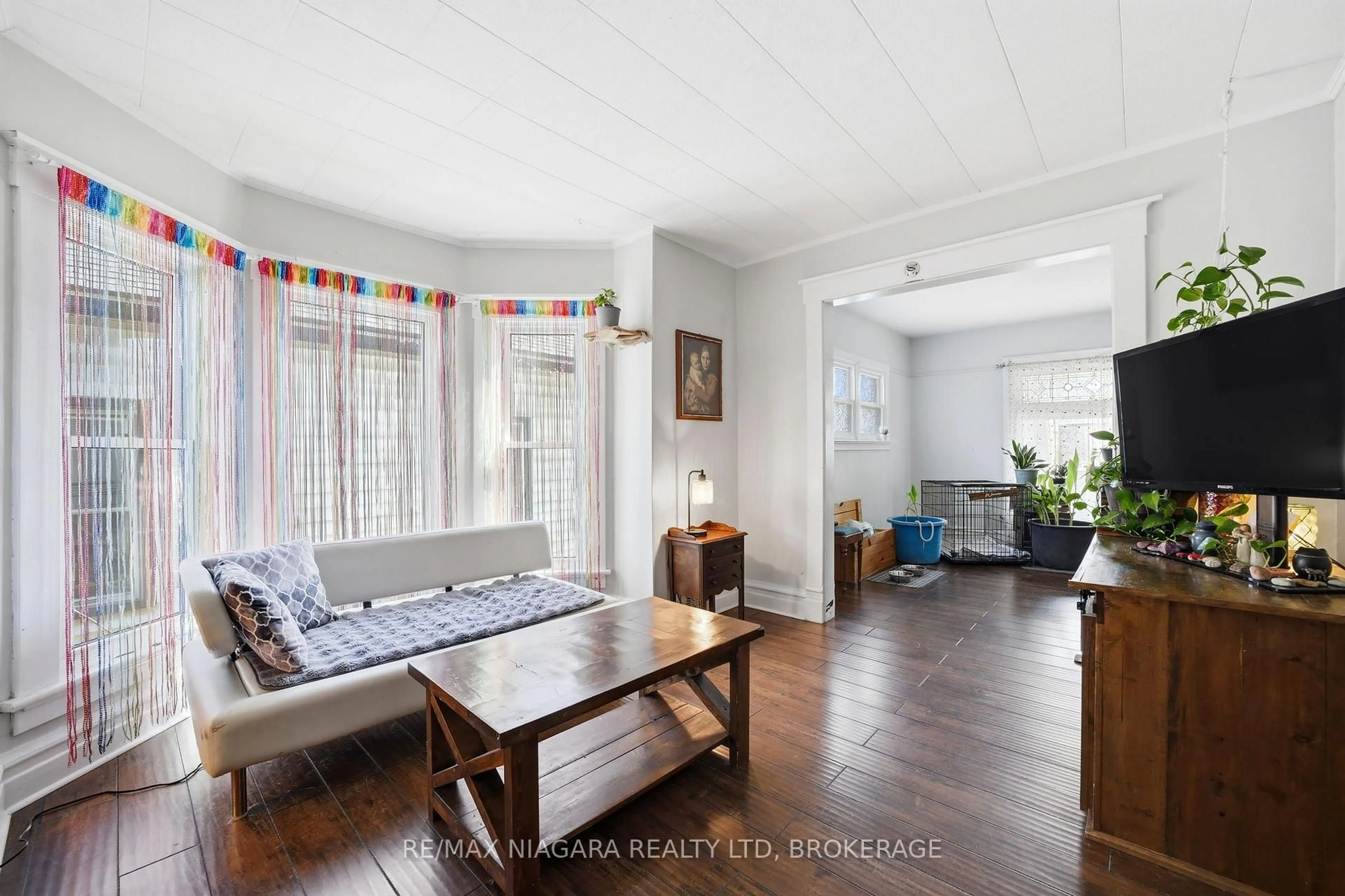 Living room with furniture, wood/laminate floor for 4919 Huron St, Niagara Falls Ontario L2E 2J4