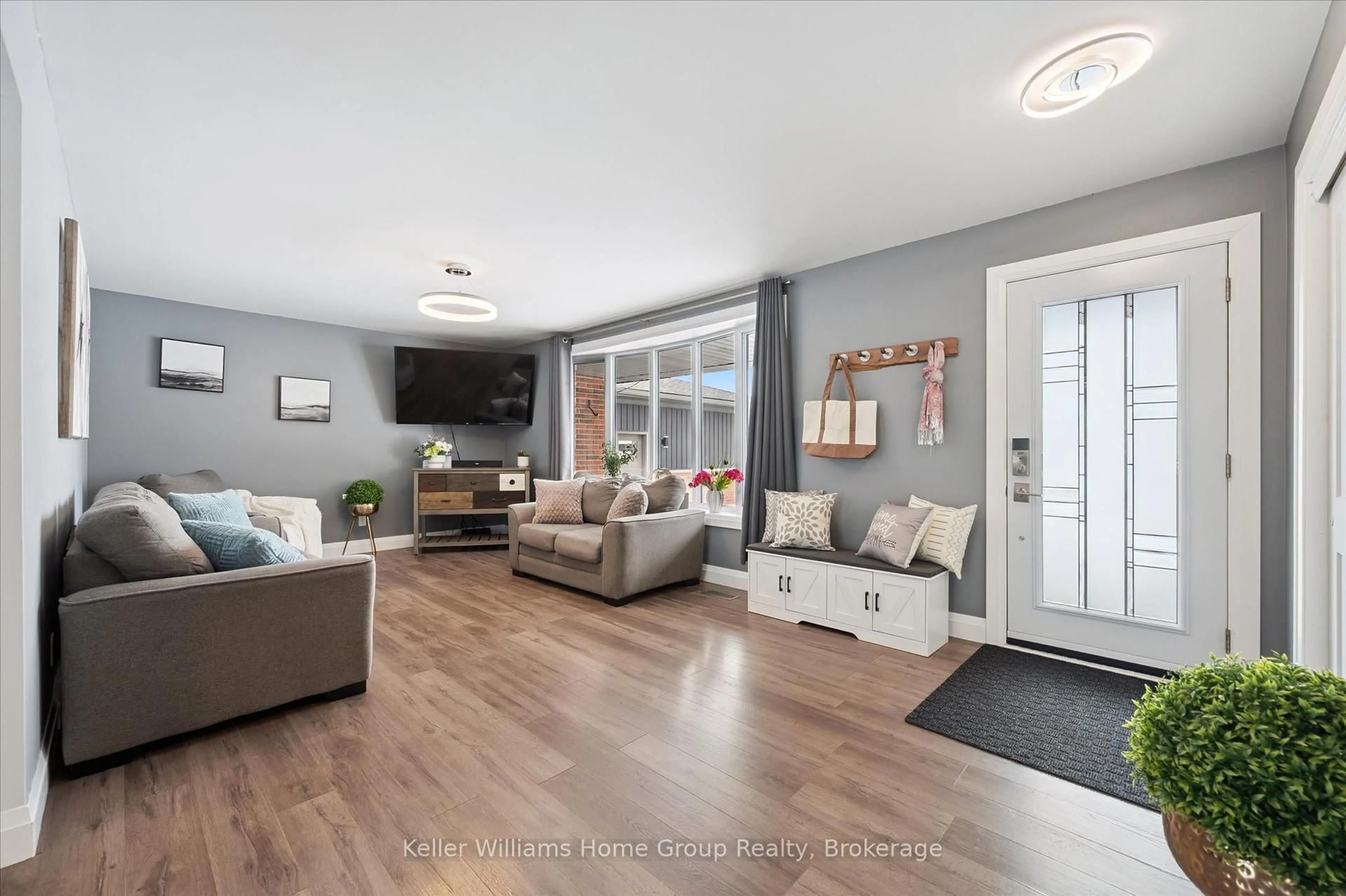 Living room with furniture, wood/laminate floor for 8378 Wellington Road 22, Centre Wellington Ontario N0B 2K0