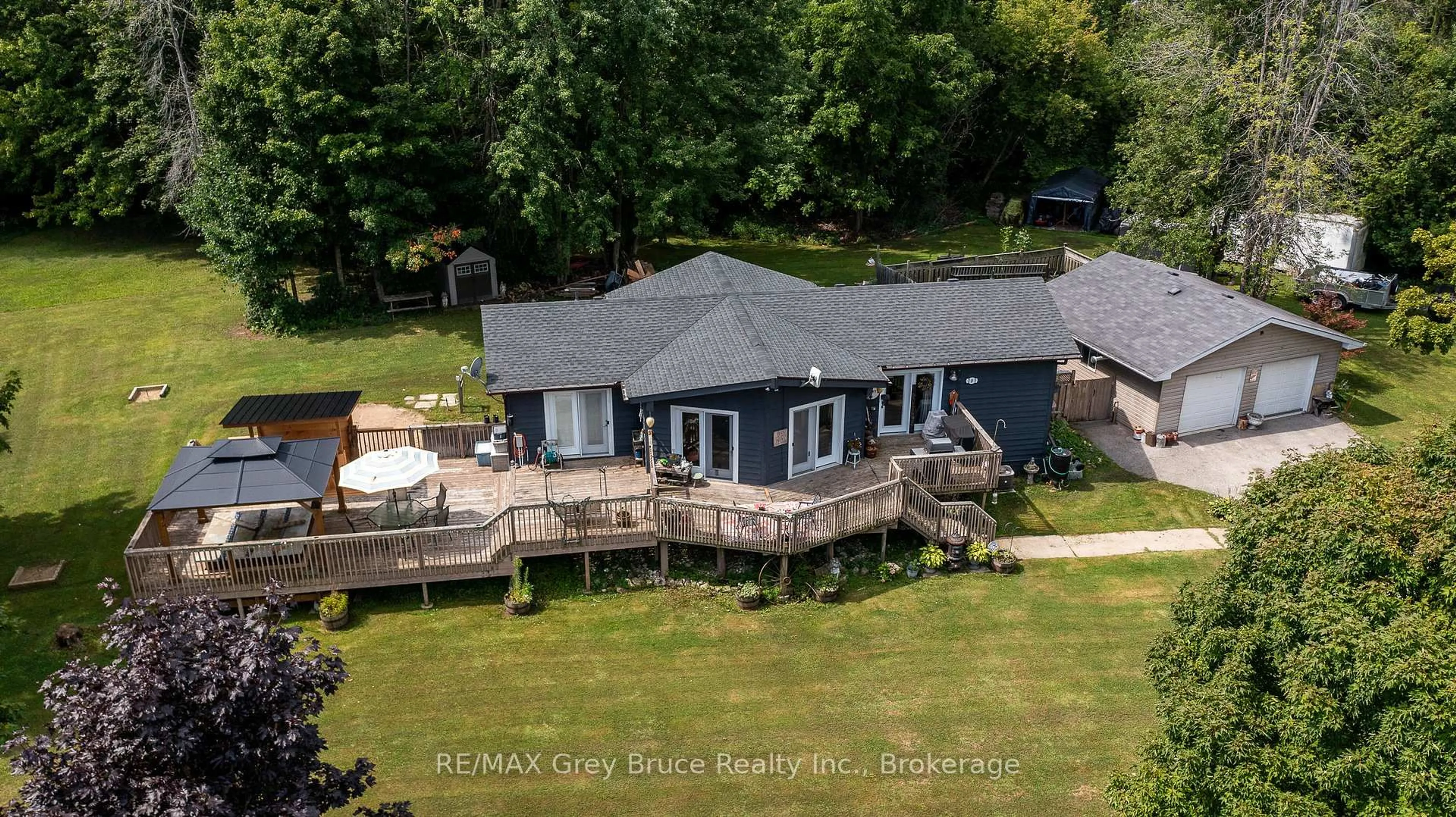 A pic from outside/outdoor area/front of a property/back of a property/a pic from drone, water/lake/river/ocean view for 201 DIVISION St, Georgian Bluffs Ontario N0H 2K0