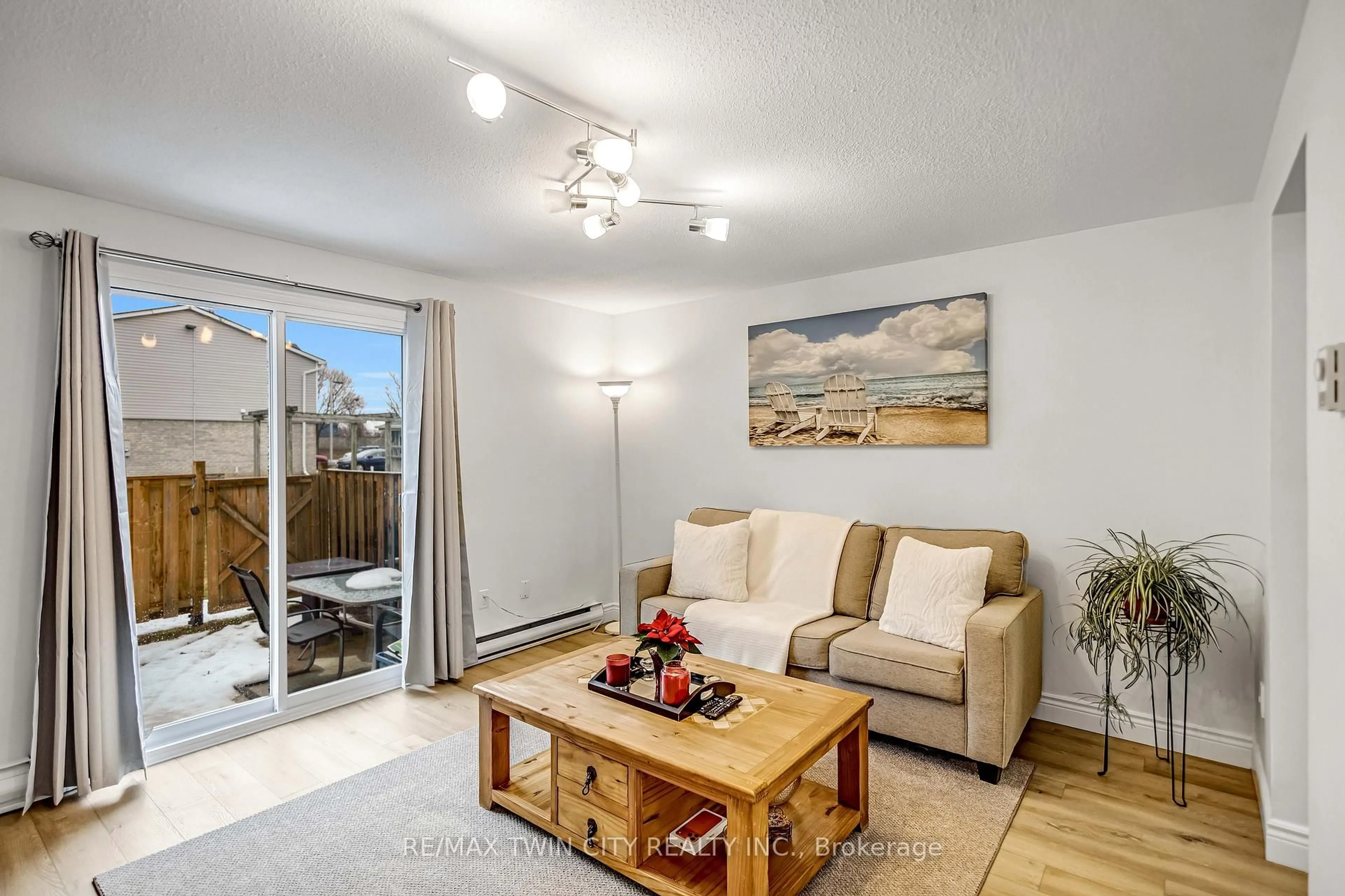 Living room with furniture, wood/laminate floor for 494 Grey St #16, Brantford Ontario N3S 7S6