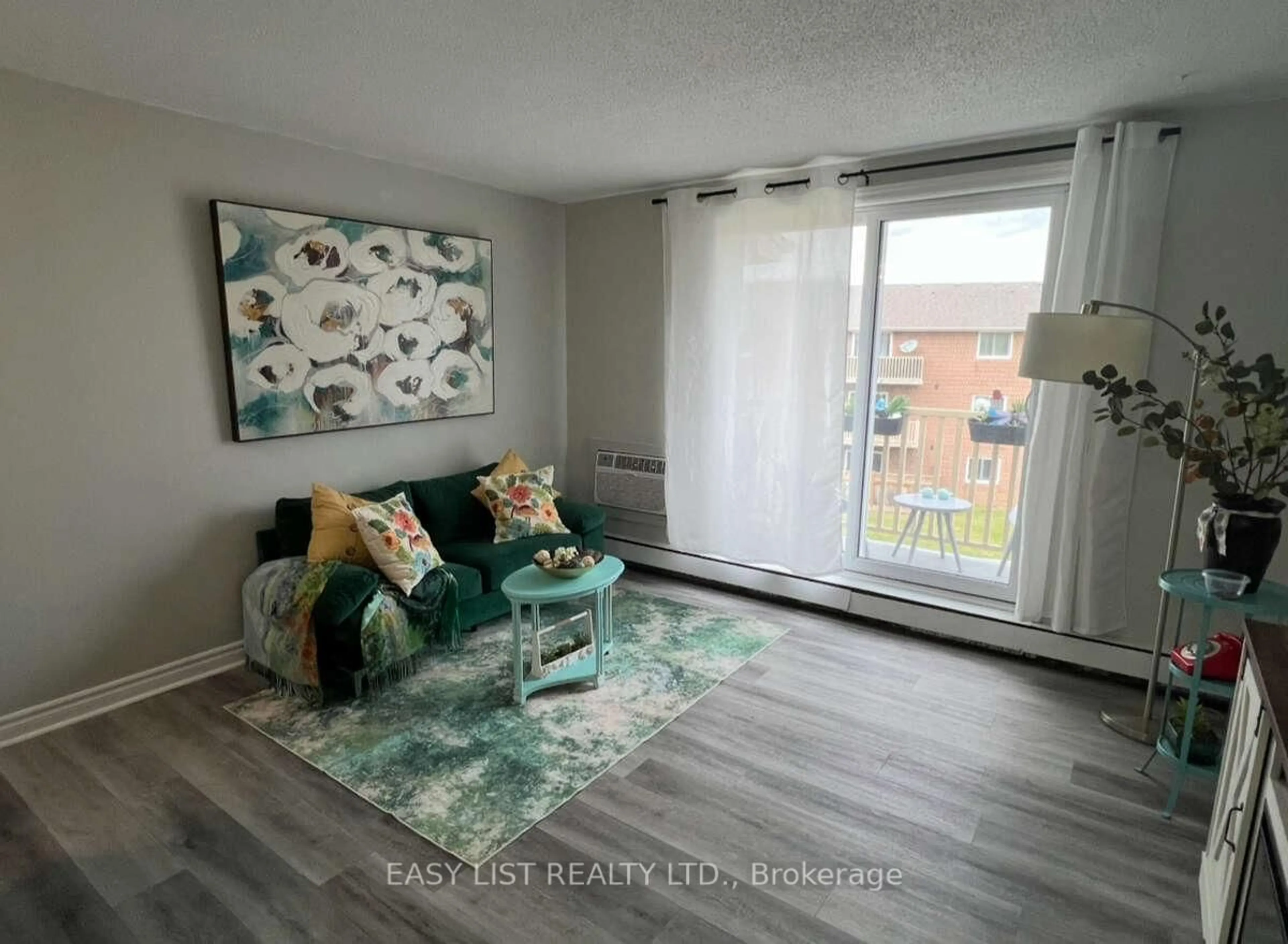 Living room with furniture, wood/laminate floor for 1582 Ernest Ave #304, London South Ontario N6E 2S4