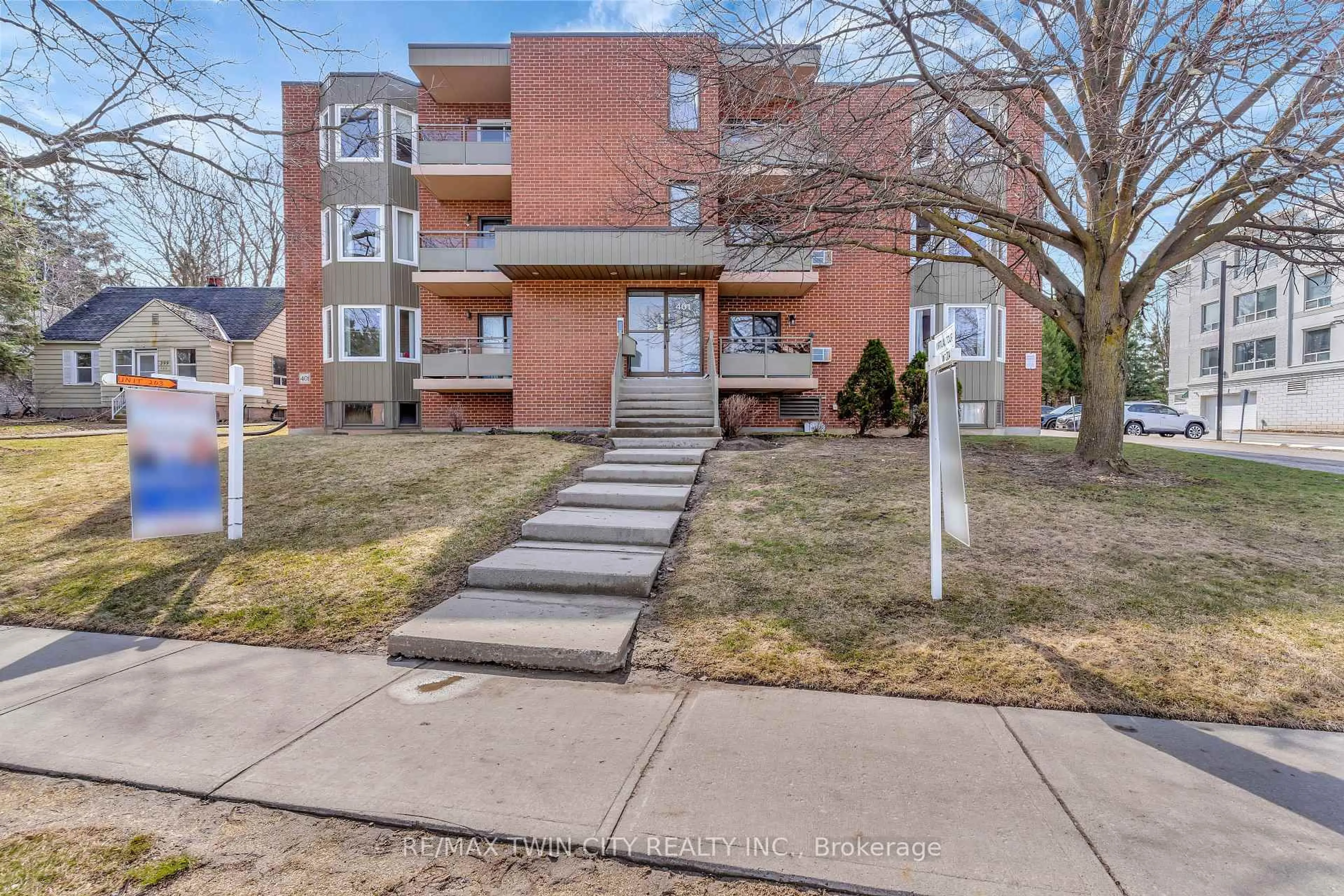 Home with brick exterior material, street for 401 Erb St #203, Waterloo Ontario N2L 1W7