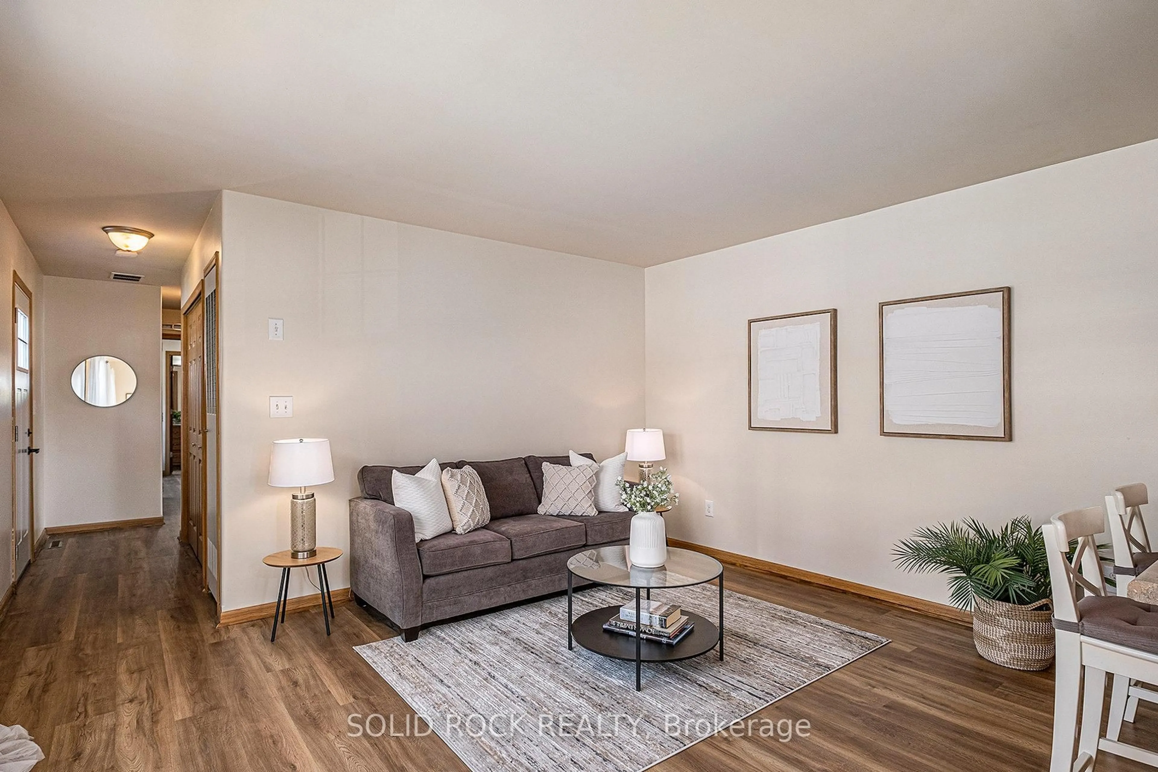 Living room with furniture, wood/laminate floor for 65 Vanier Rd, Ottawa Ontario K2H 7P6